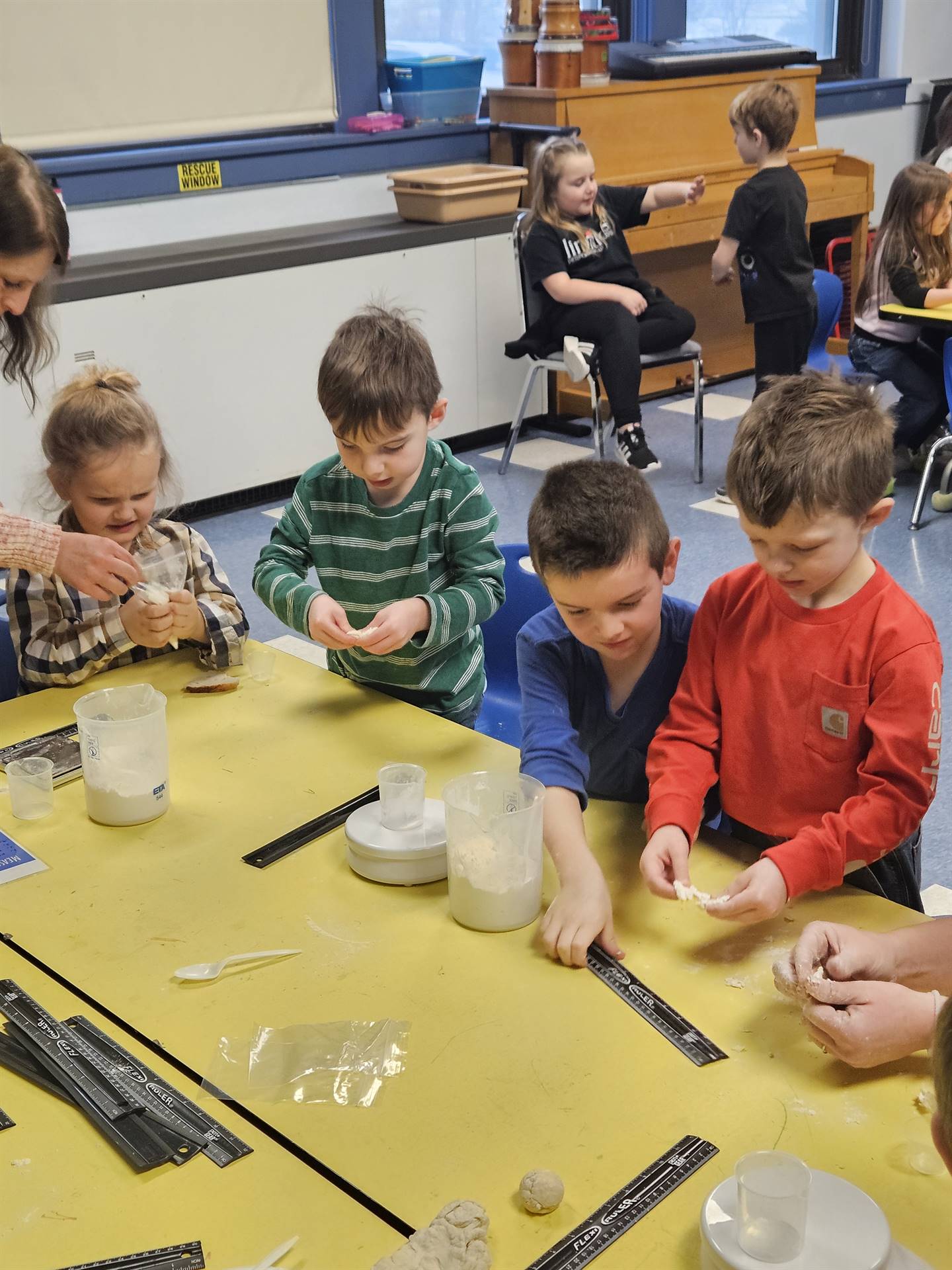 student mixing flour and water