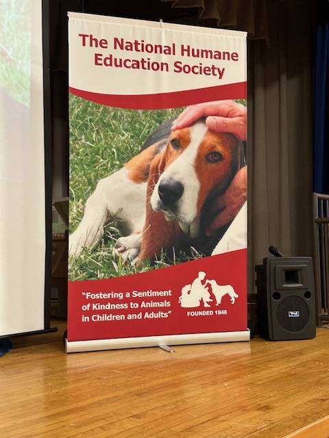 A sign that says The National Humane Education Society with a beagle photo