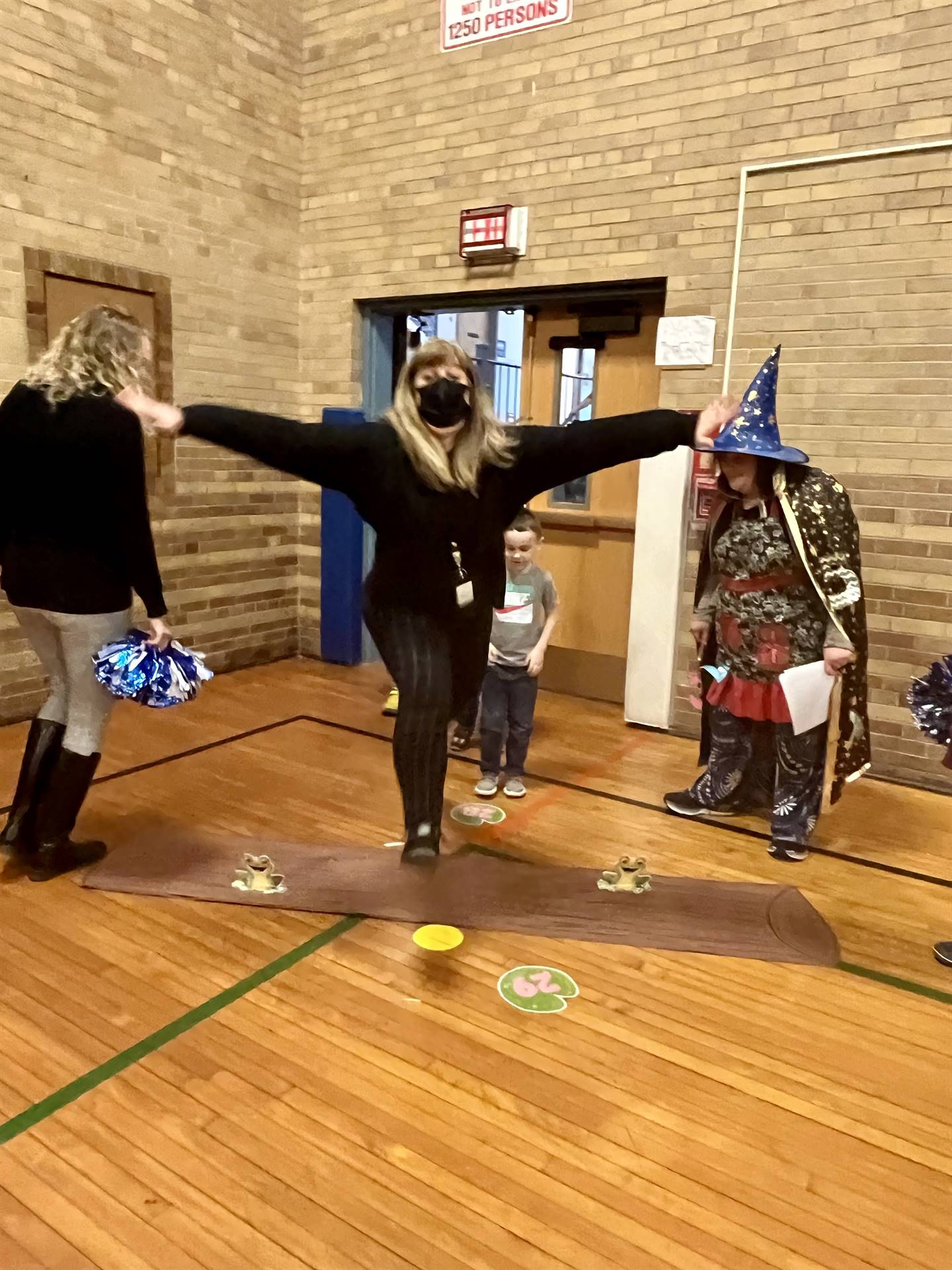 a teacher LEAPS over a paper log.