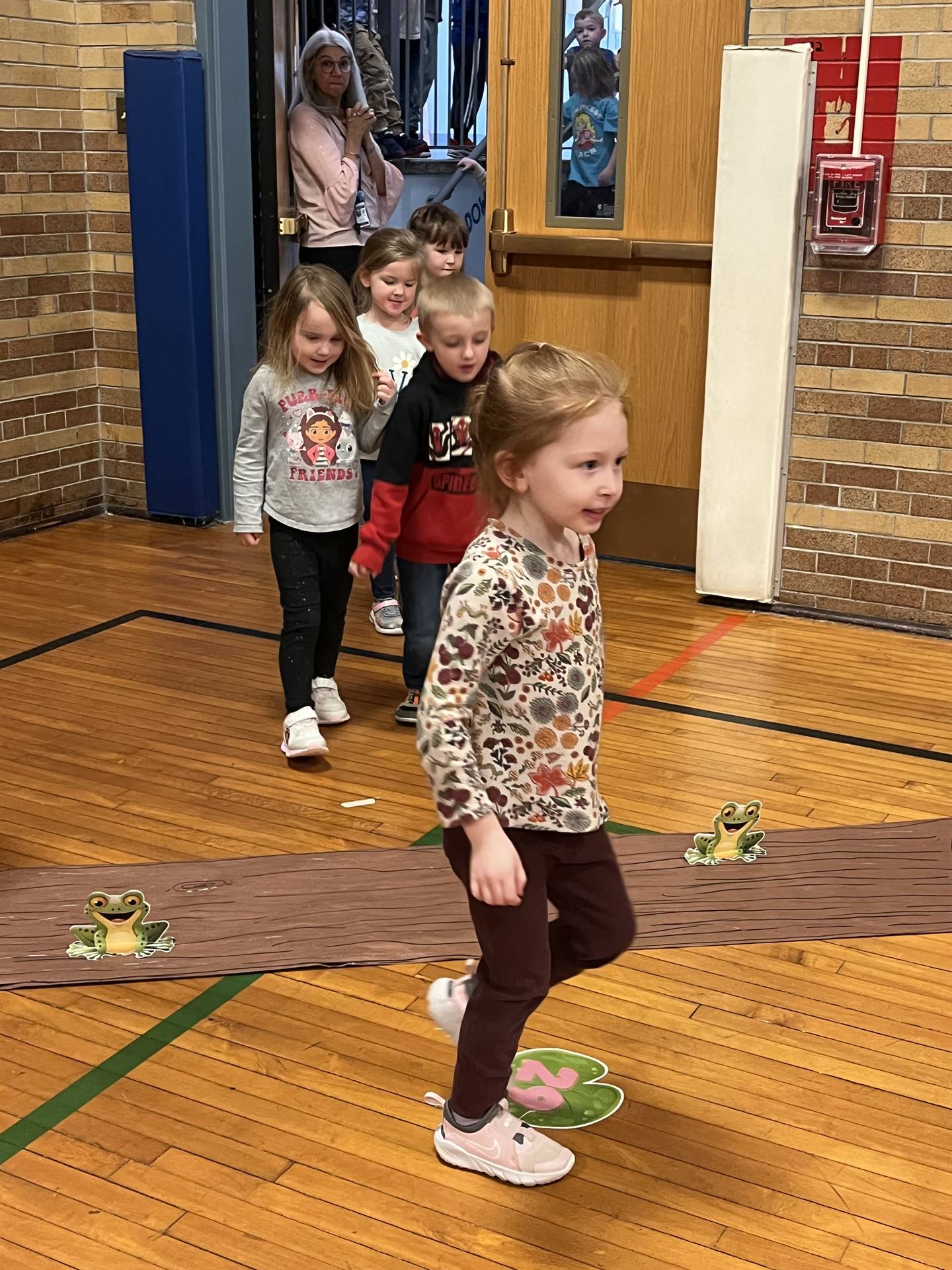 students leaping over a log for Leap day.