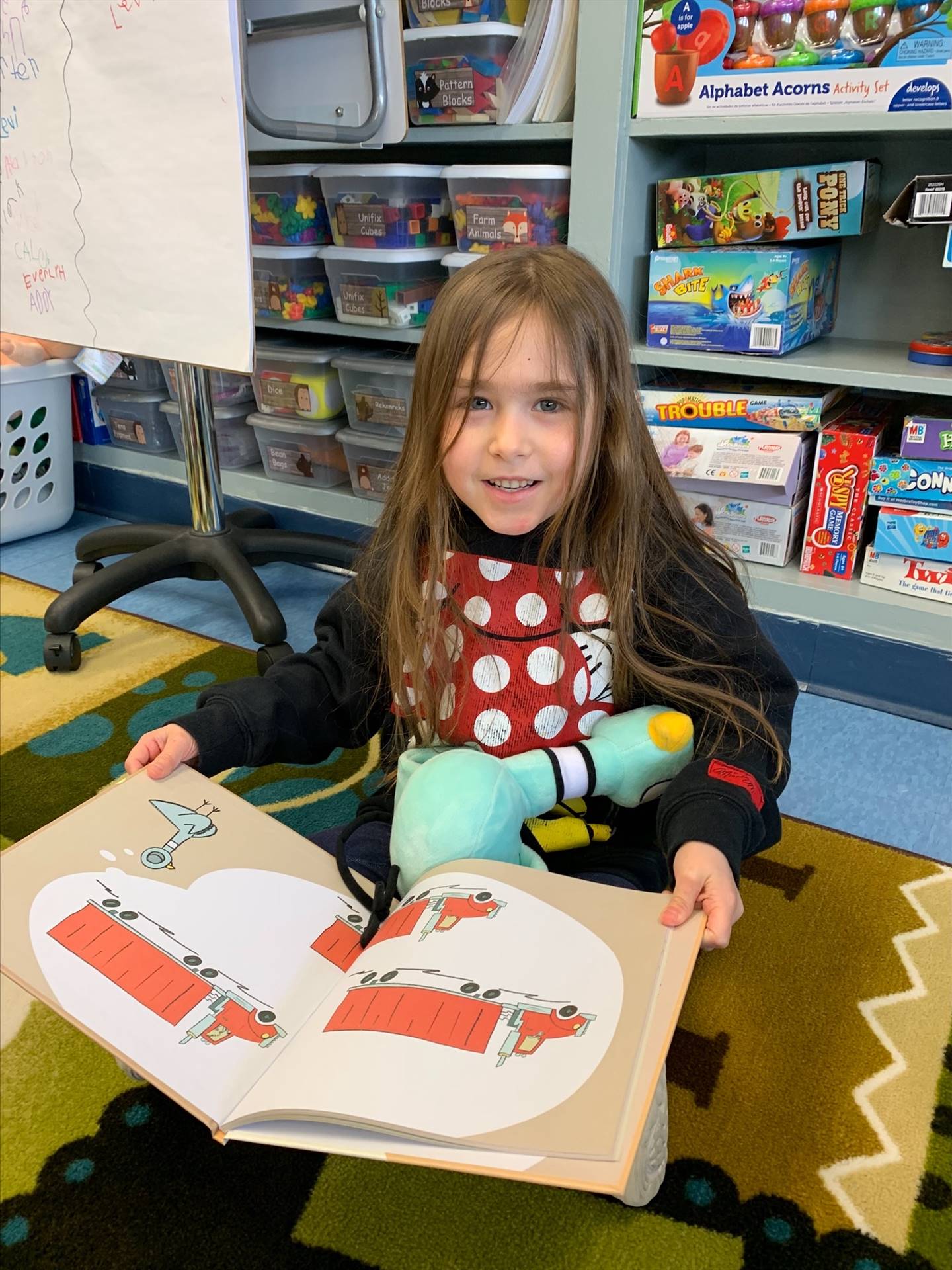 student reading to her stuffy.