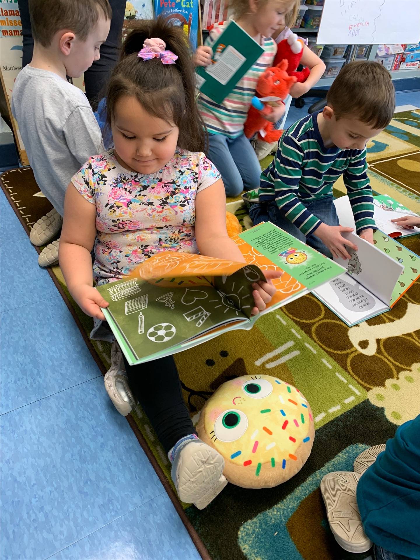 student reading to her stuffy.