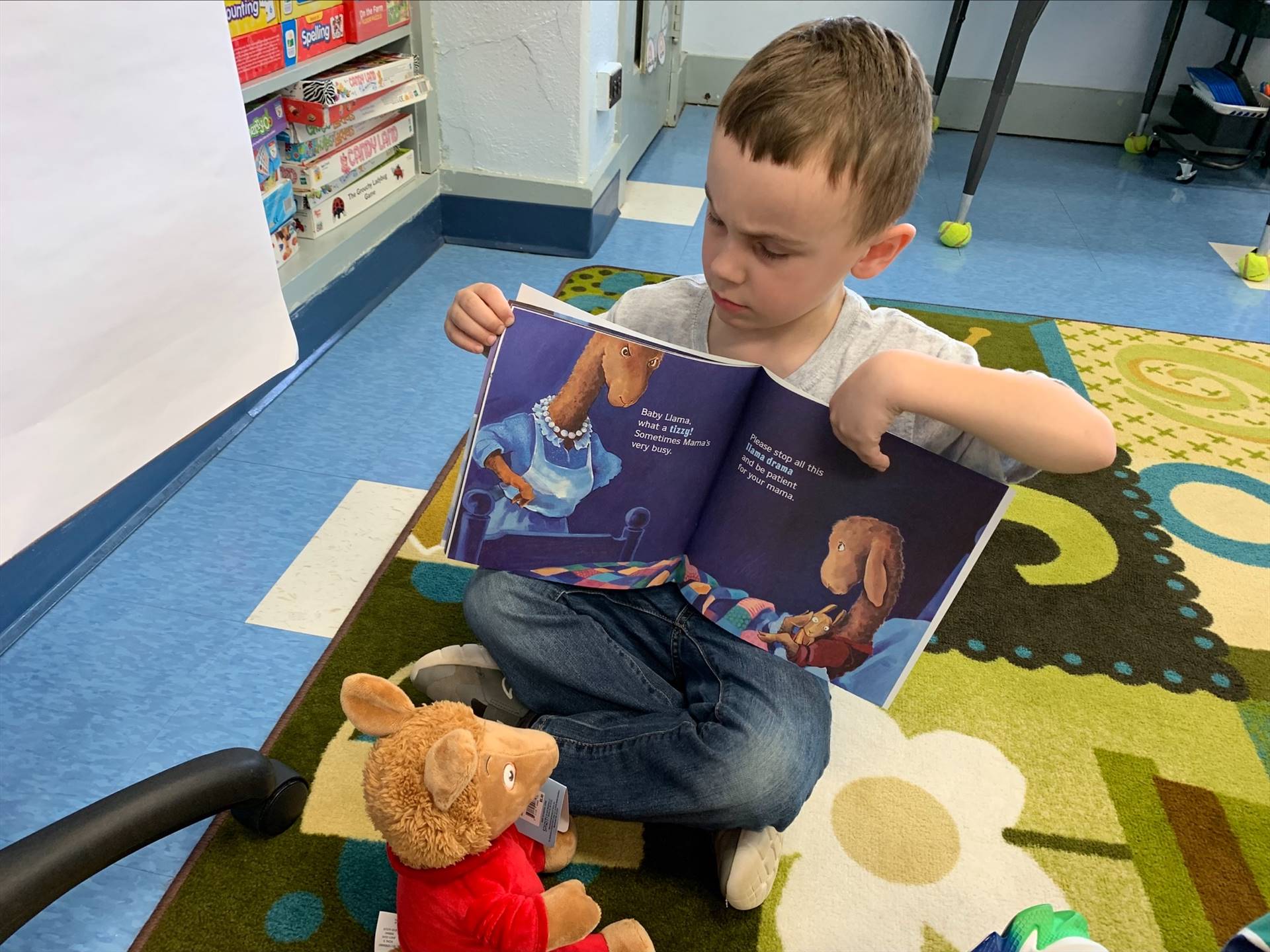 student reading to her stuffy.