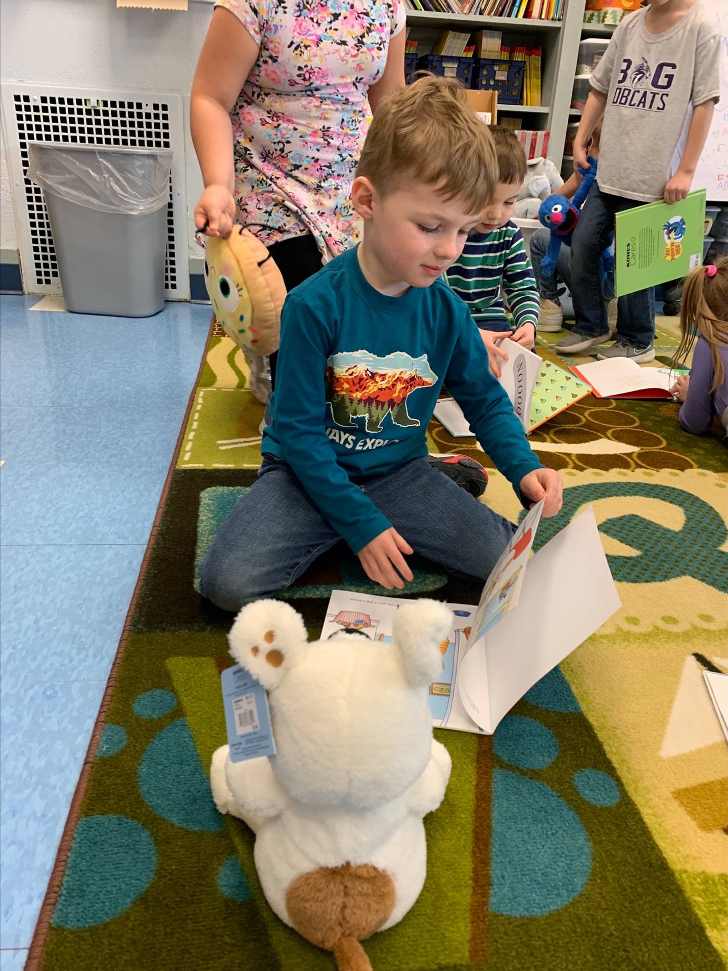 student reading to her stuffy.