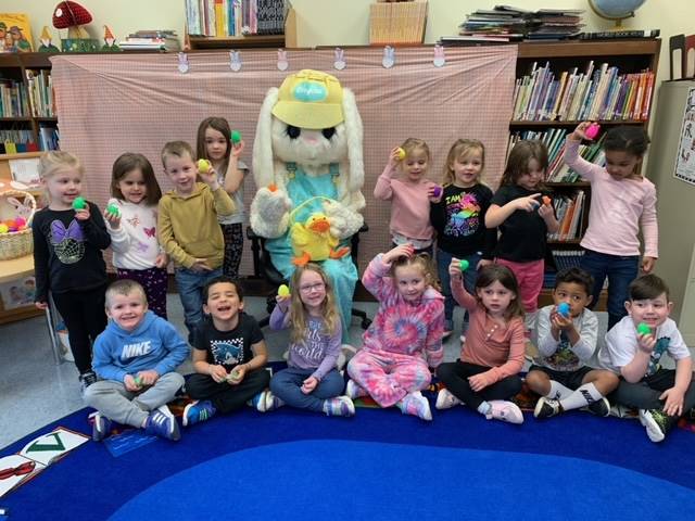 The Easter Bunny surrounded by a class