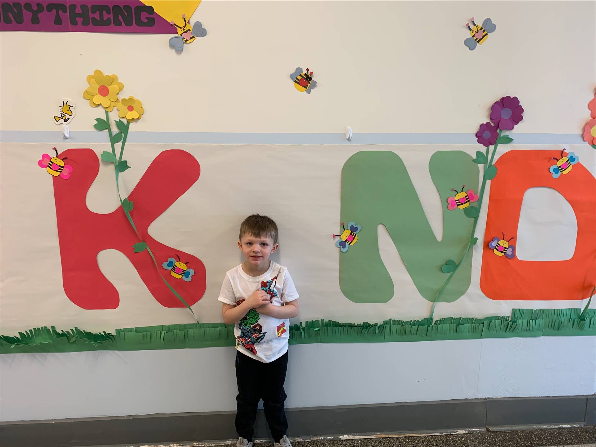 student is "I" in a large K I ND poster