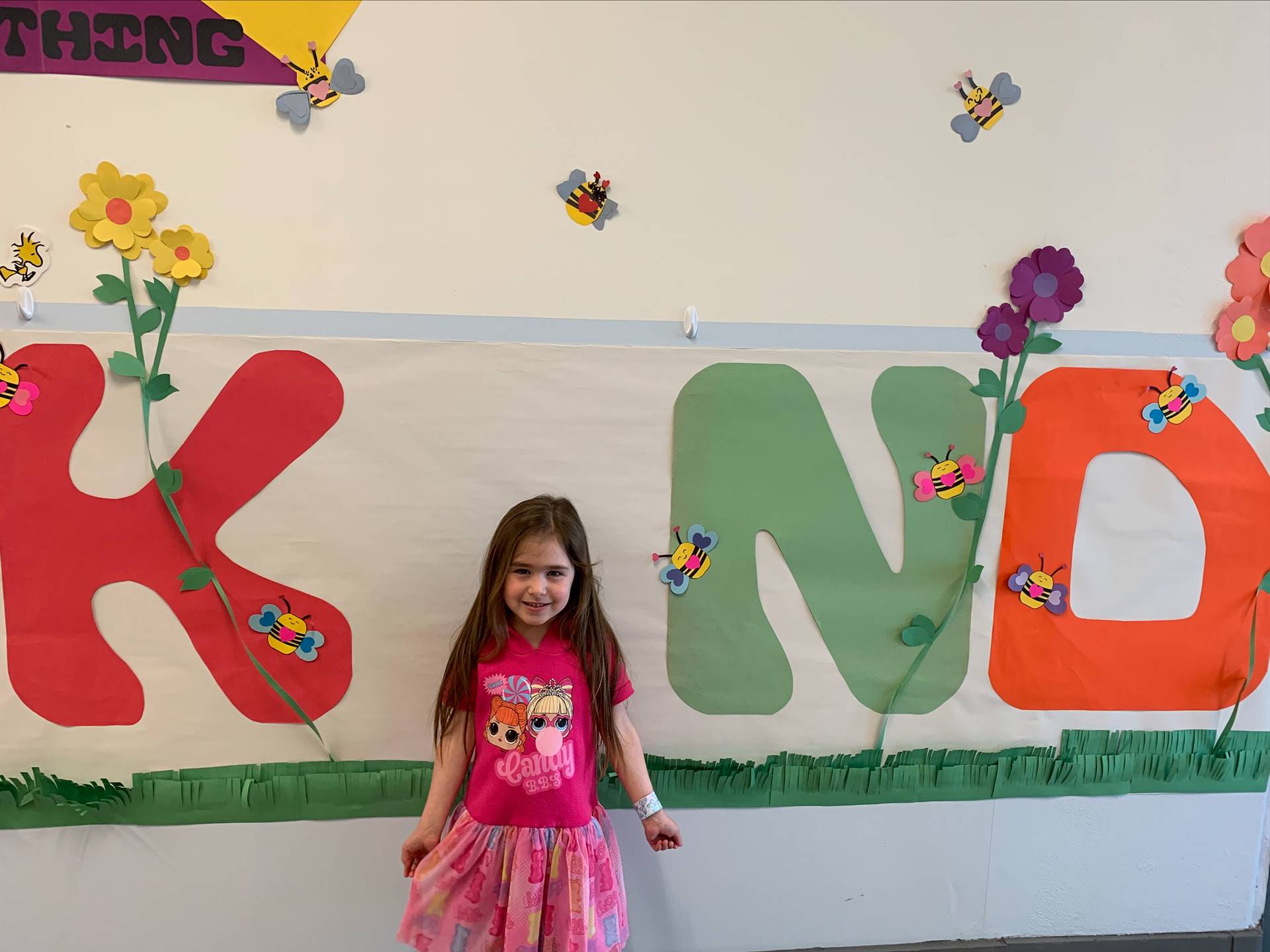 student is "I" in a large K I ND poster