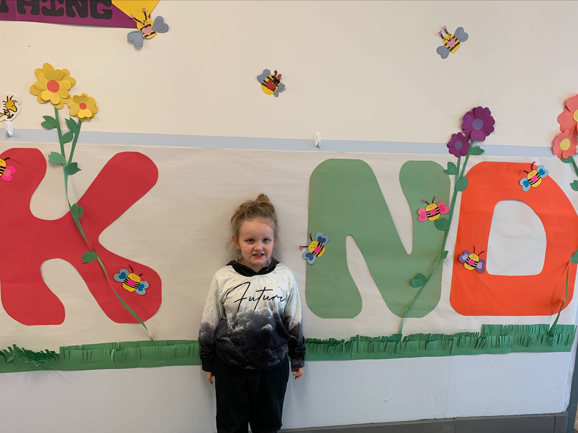 student is "I" in a large K I ND poster