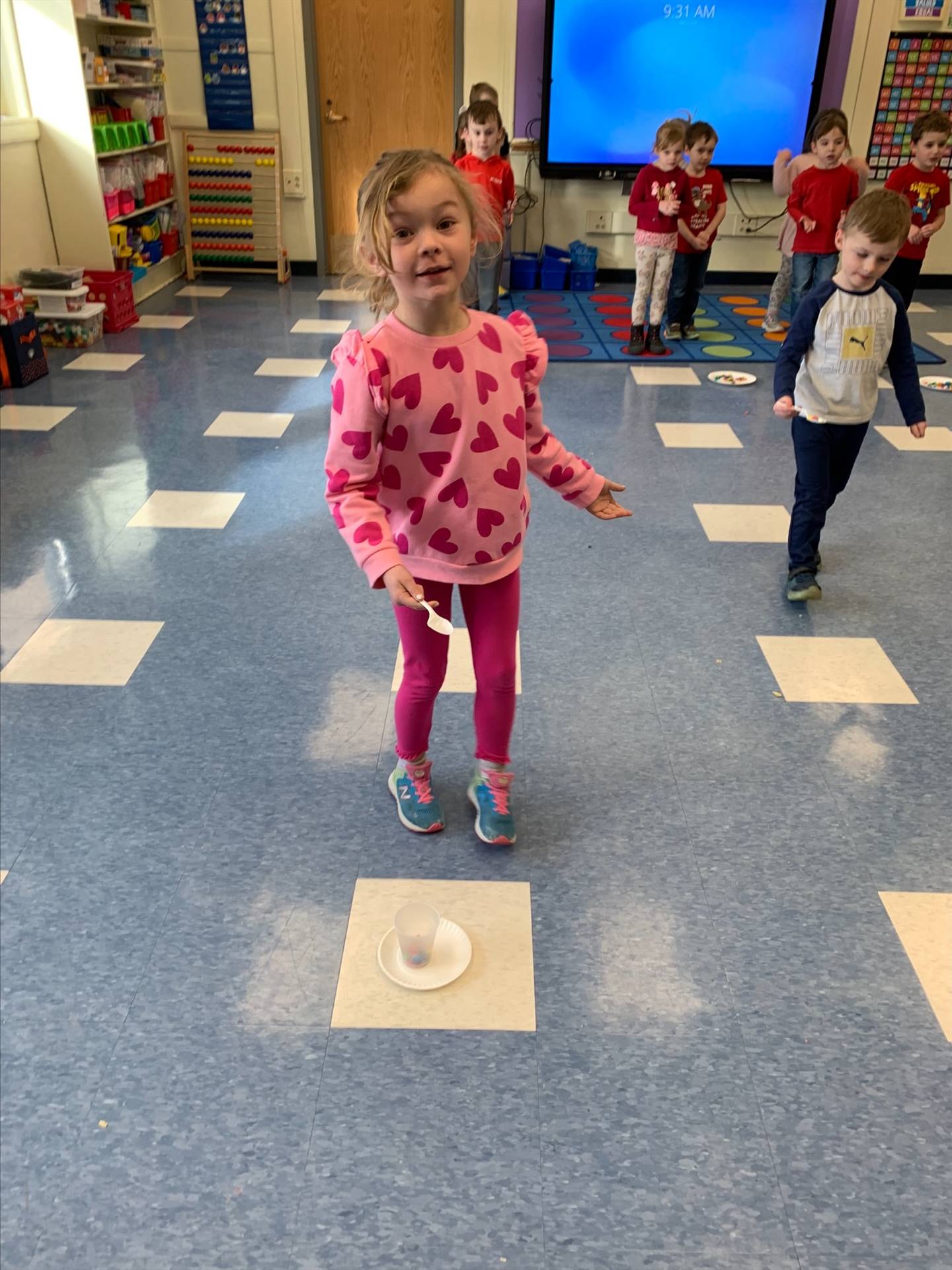 student playing a game with plate on floor.