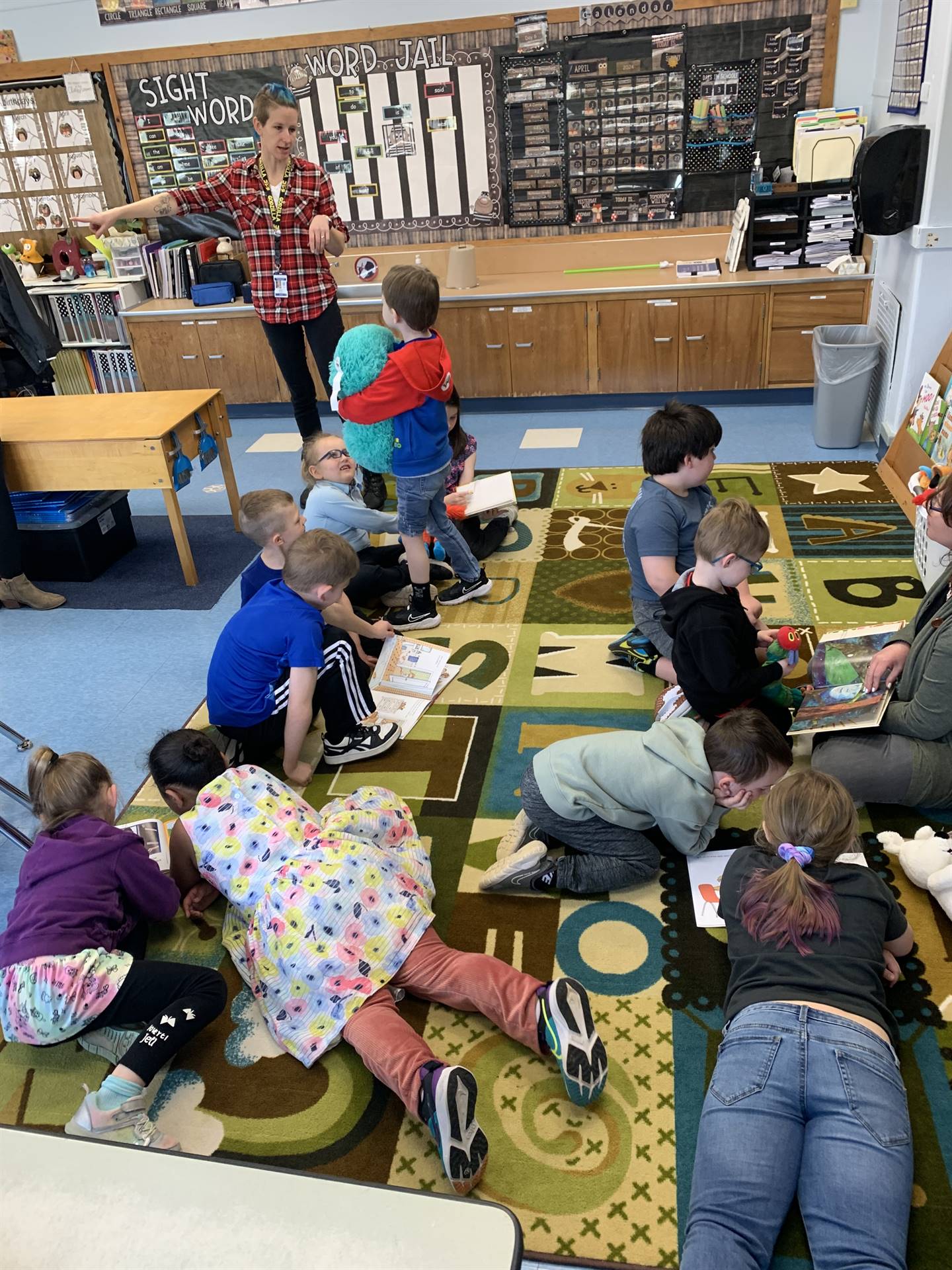 students on floor reading books.