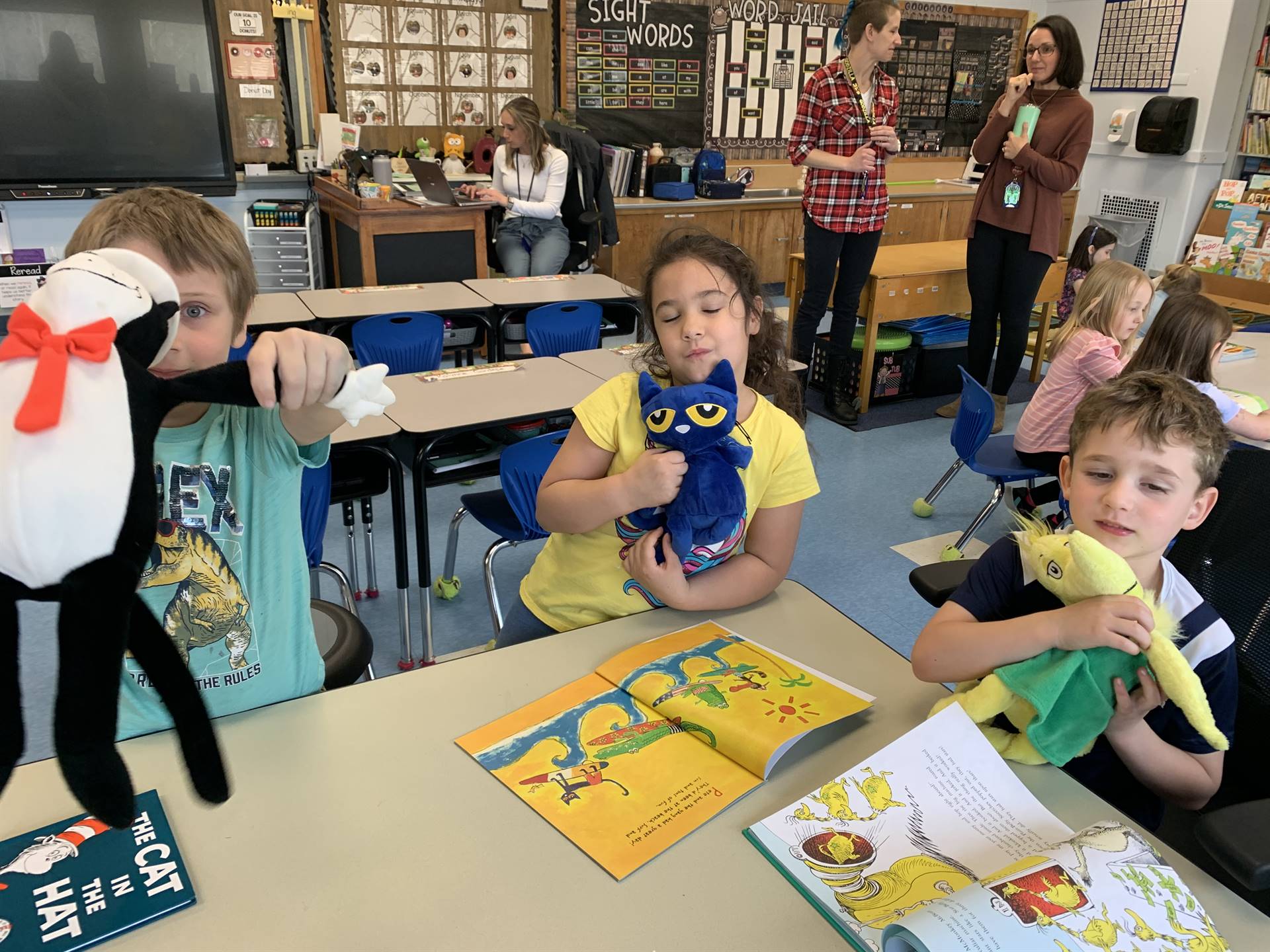 3 students reading together with their stuffs.