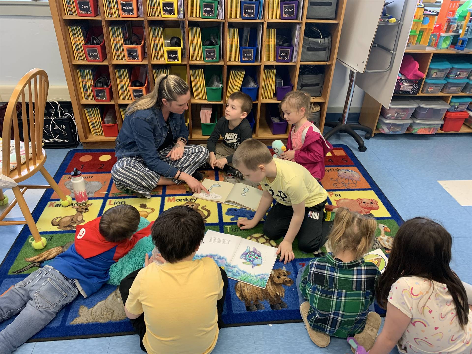 students on floor reading books.