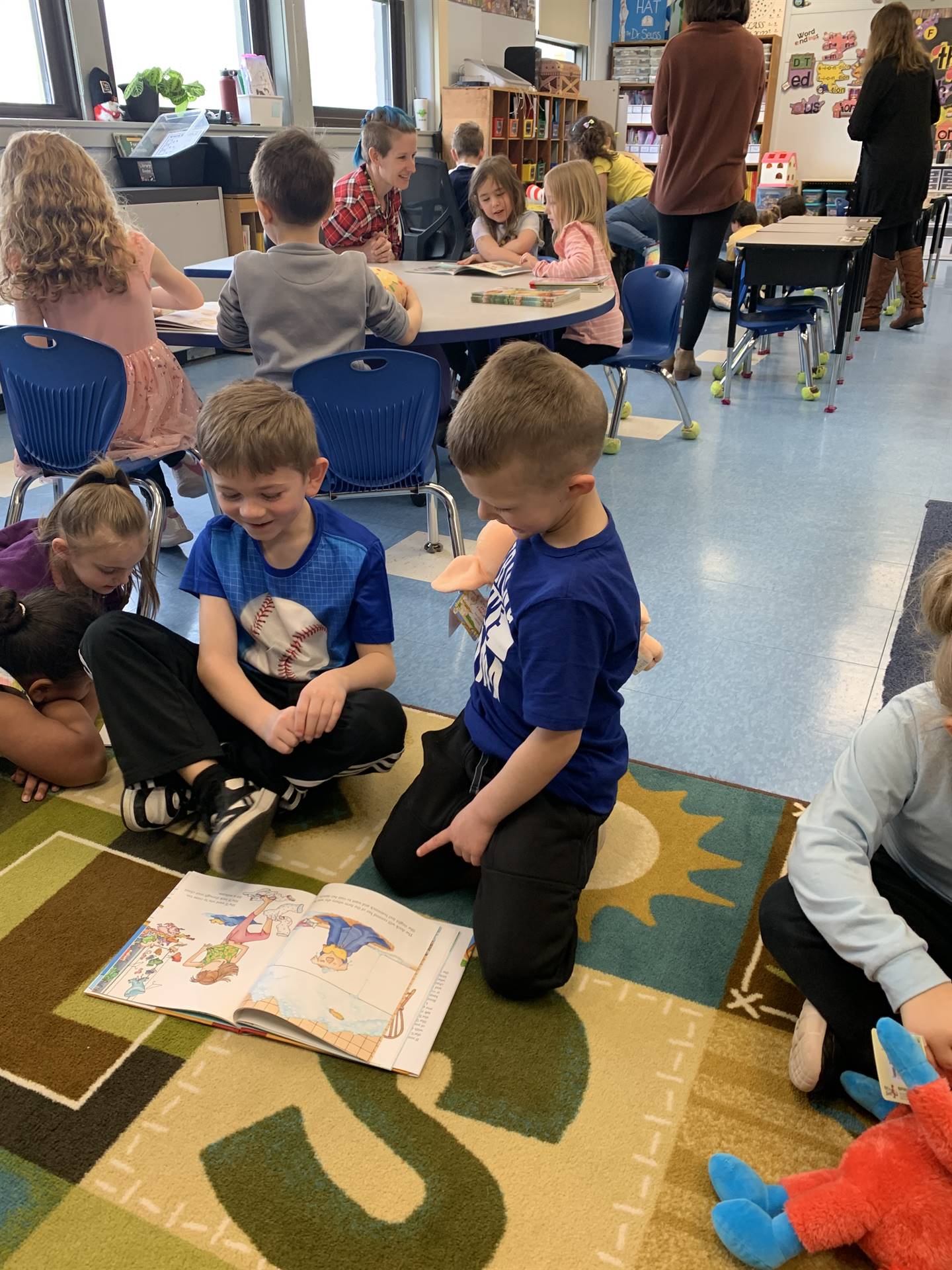 2 students on floor reading books.