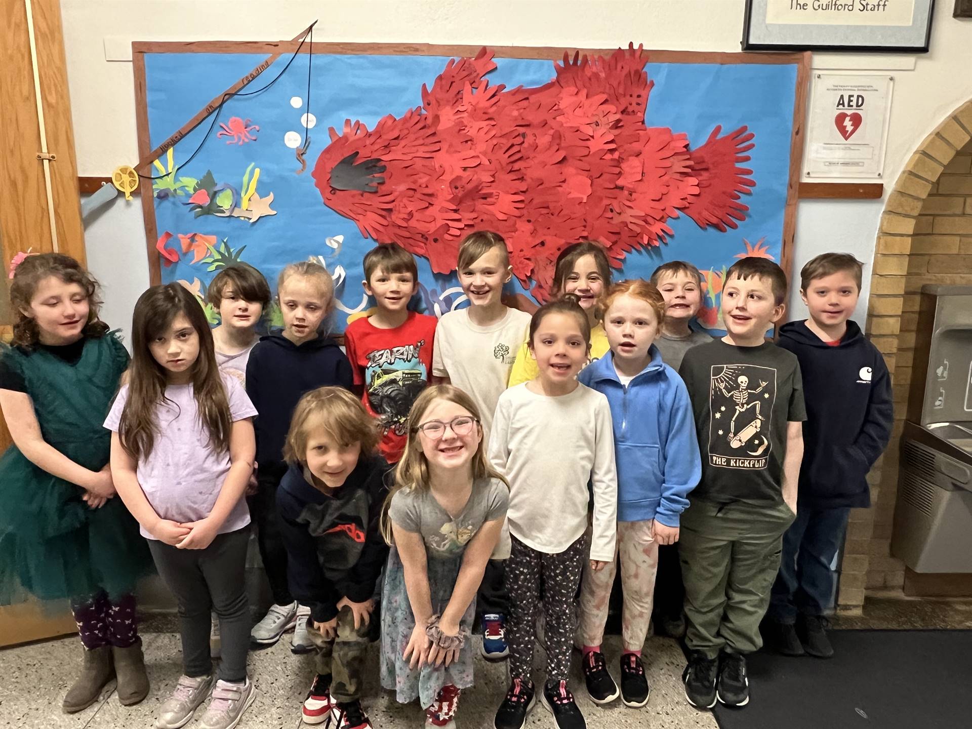 students with a background of red fish on blue background