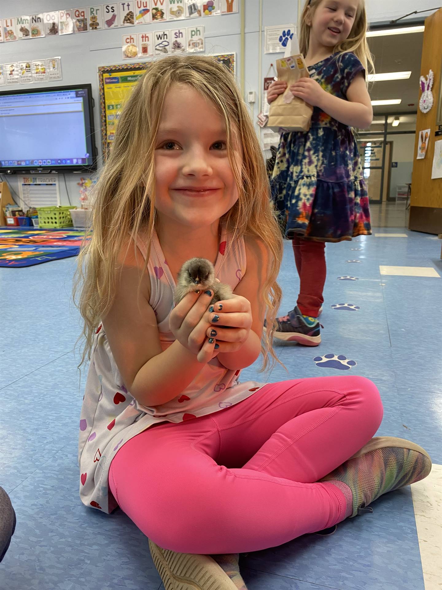 a student holds a chick