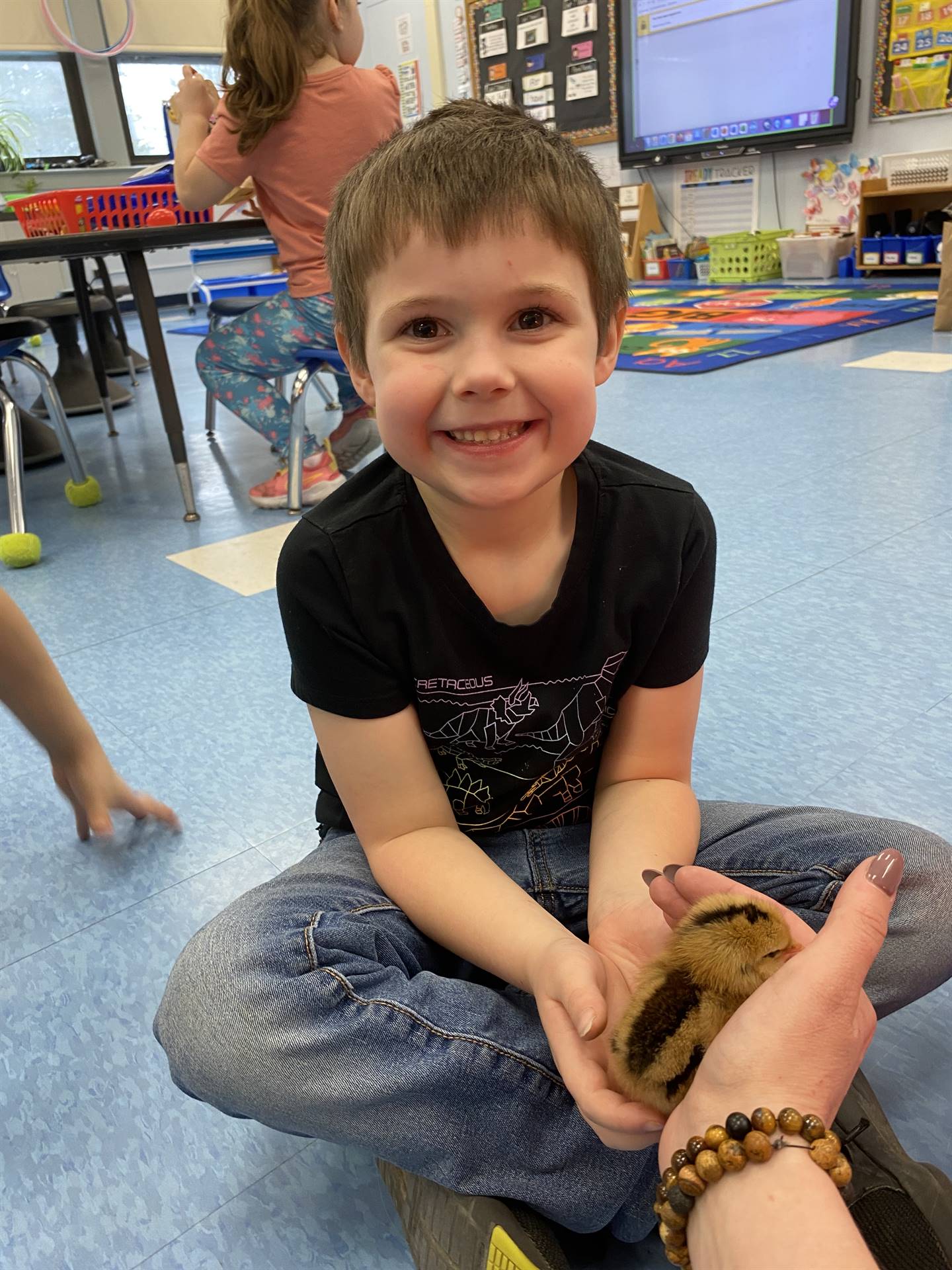 a student holds a chick