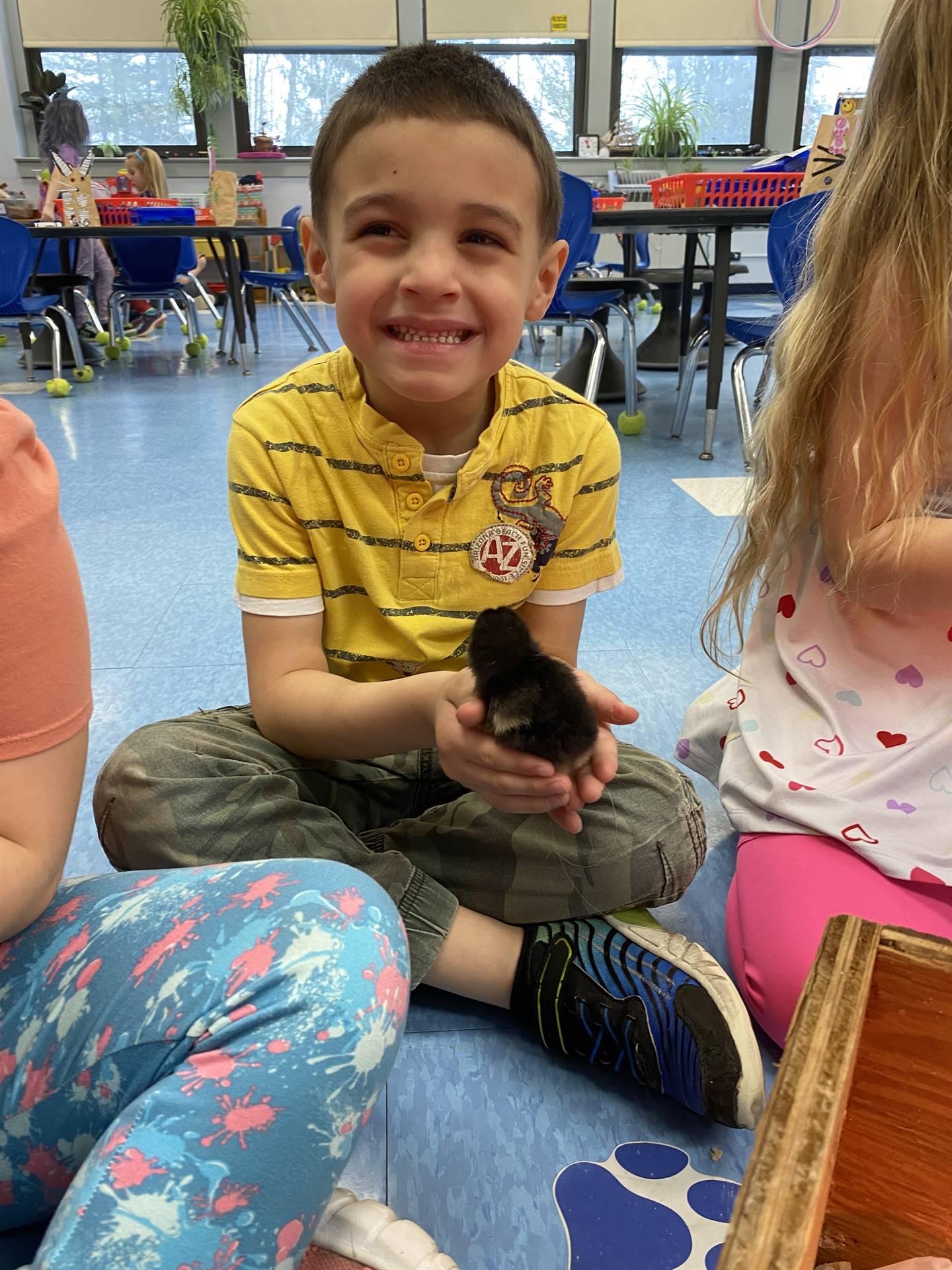 a student holds a chick