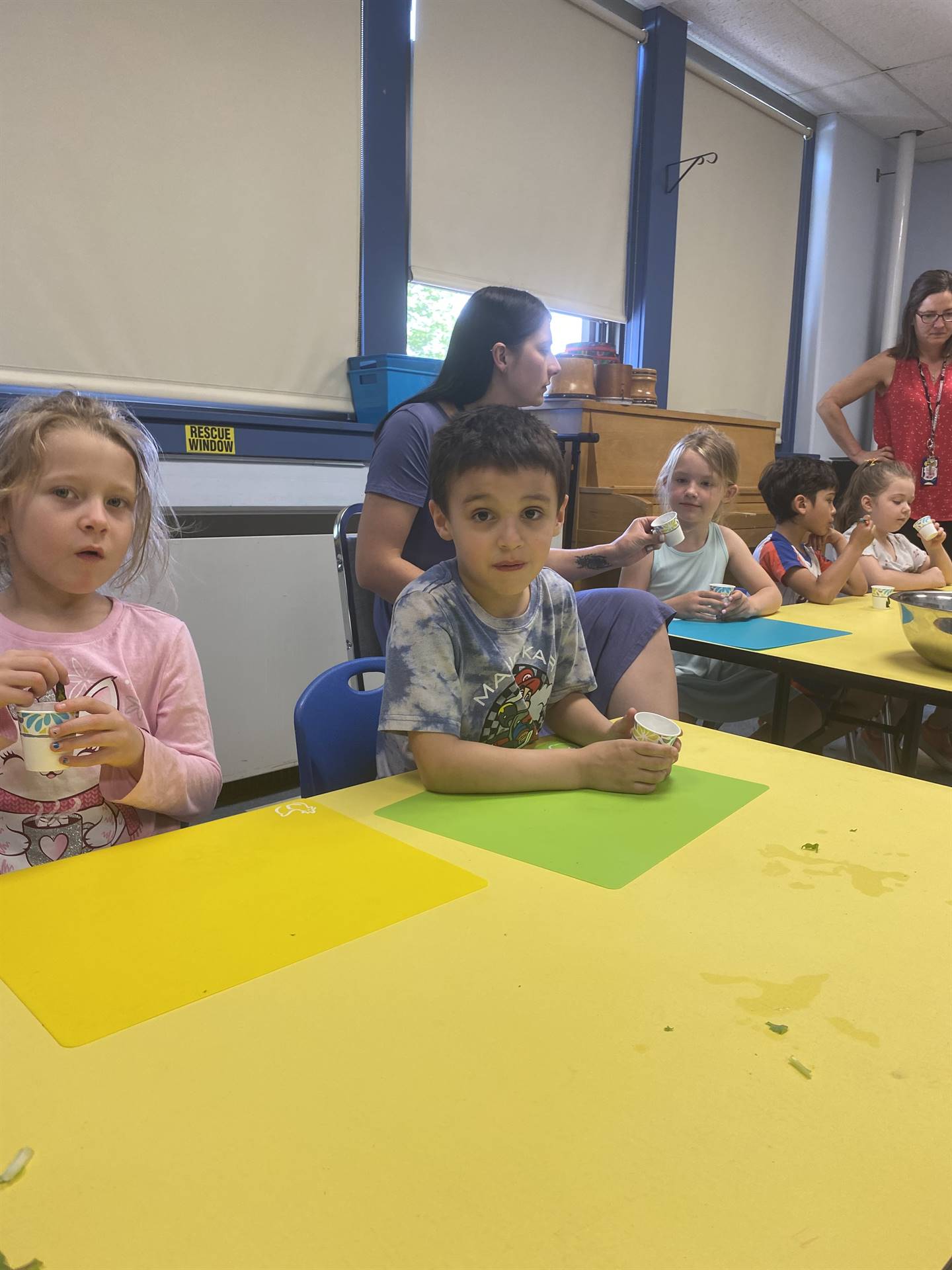  students eating cooked swiss chard greens.