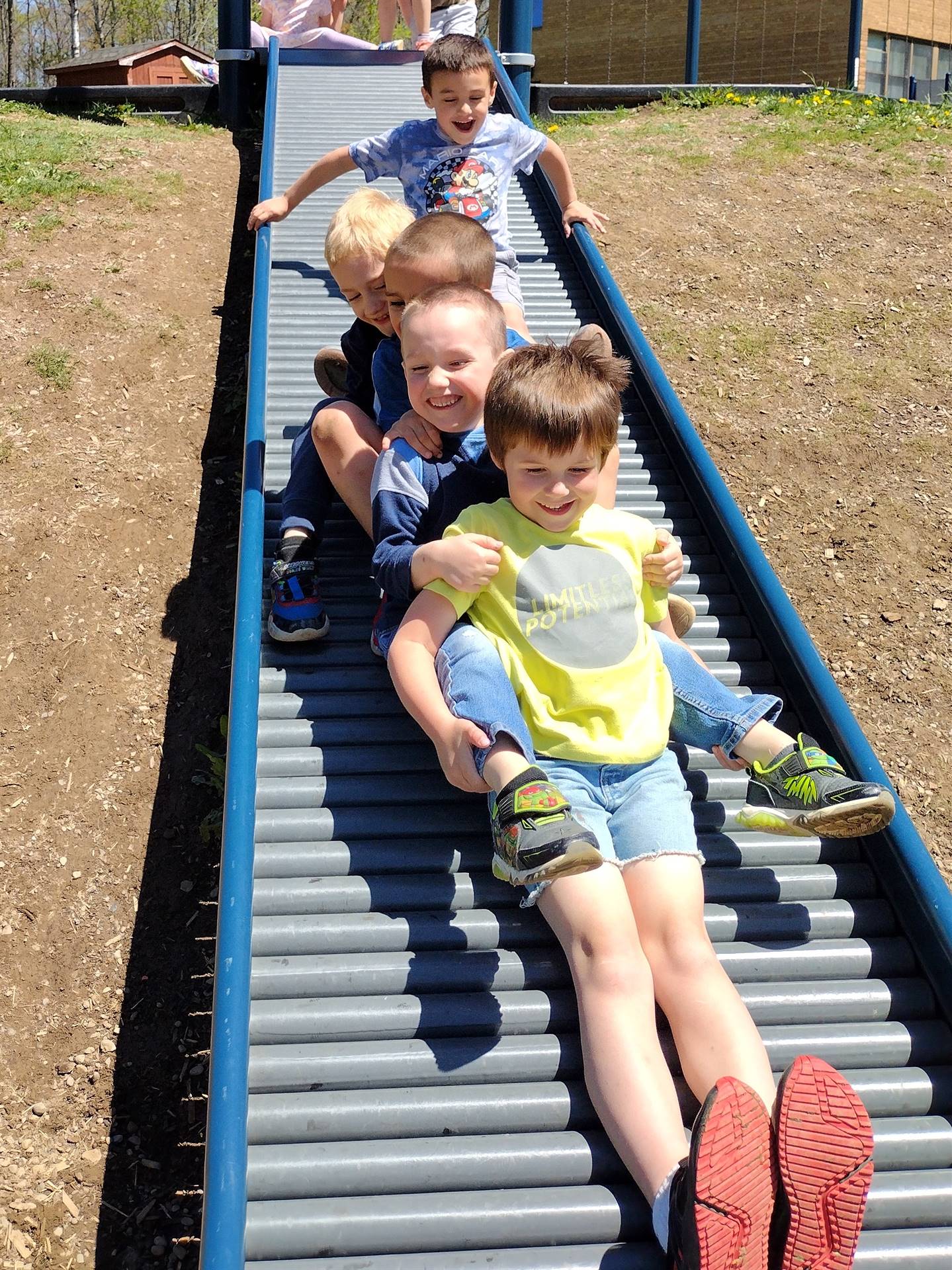 a group of students going down a slide