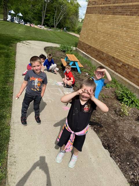 students outside in pollinator garden.