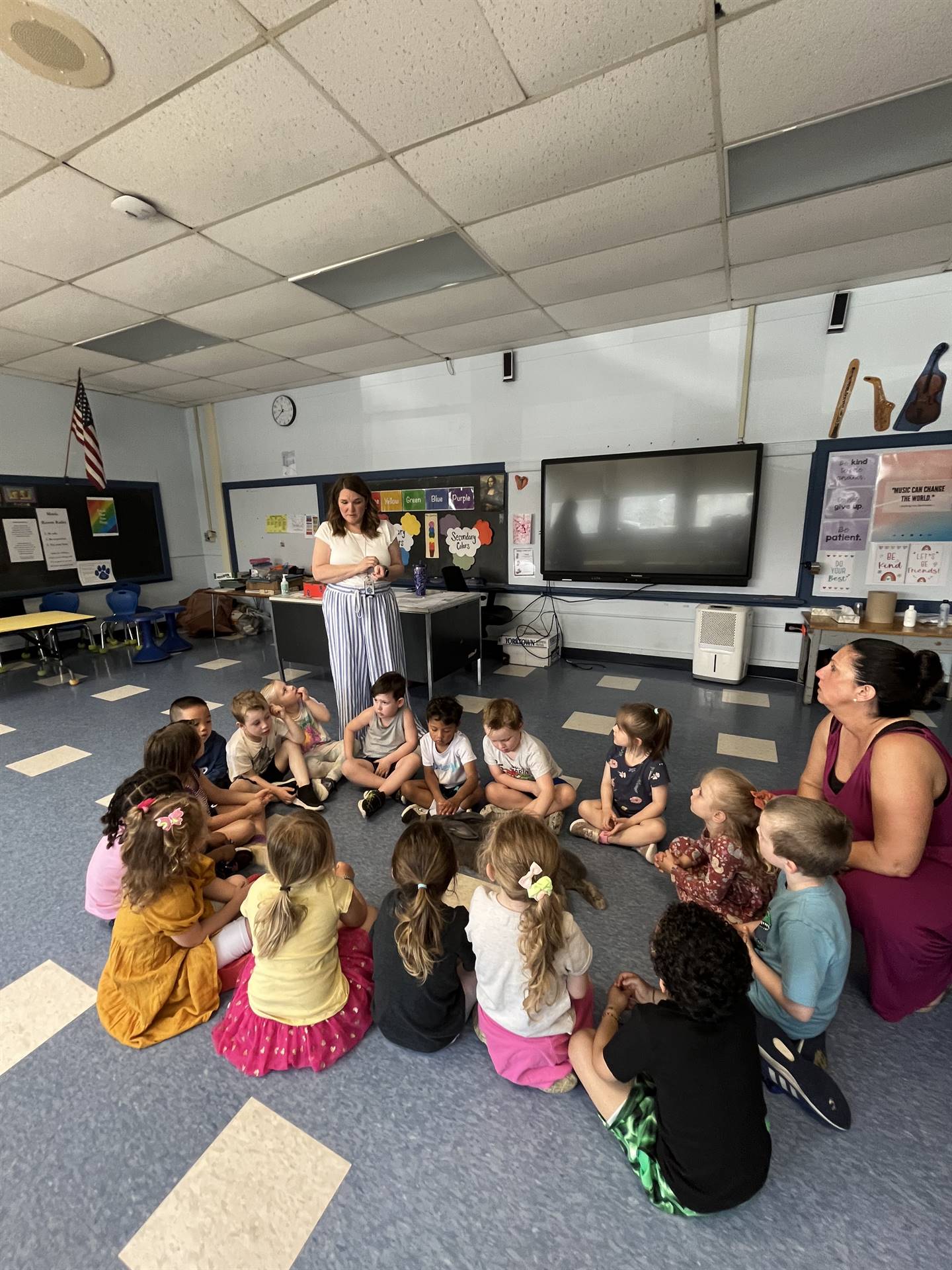 students petting a large gray bunny and learning about it