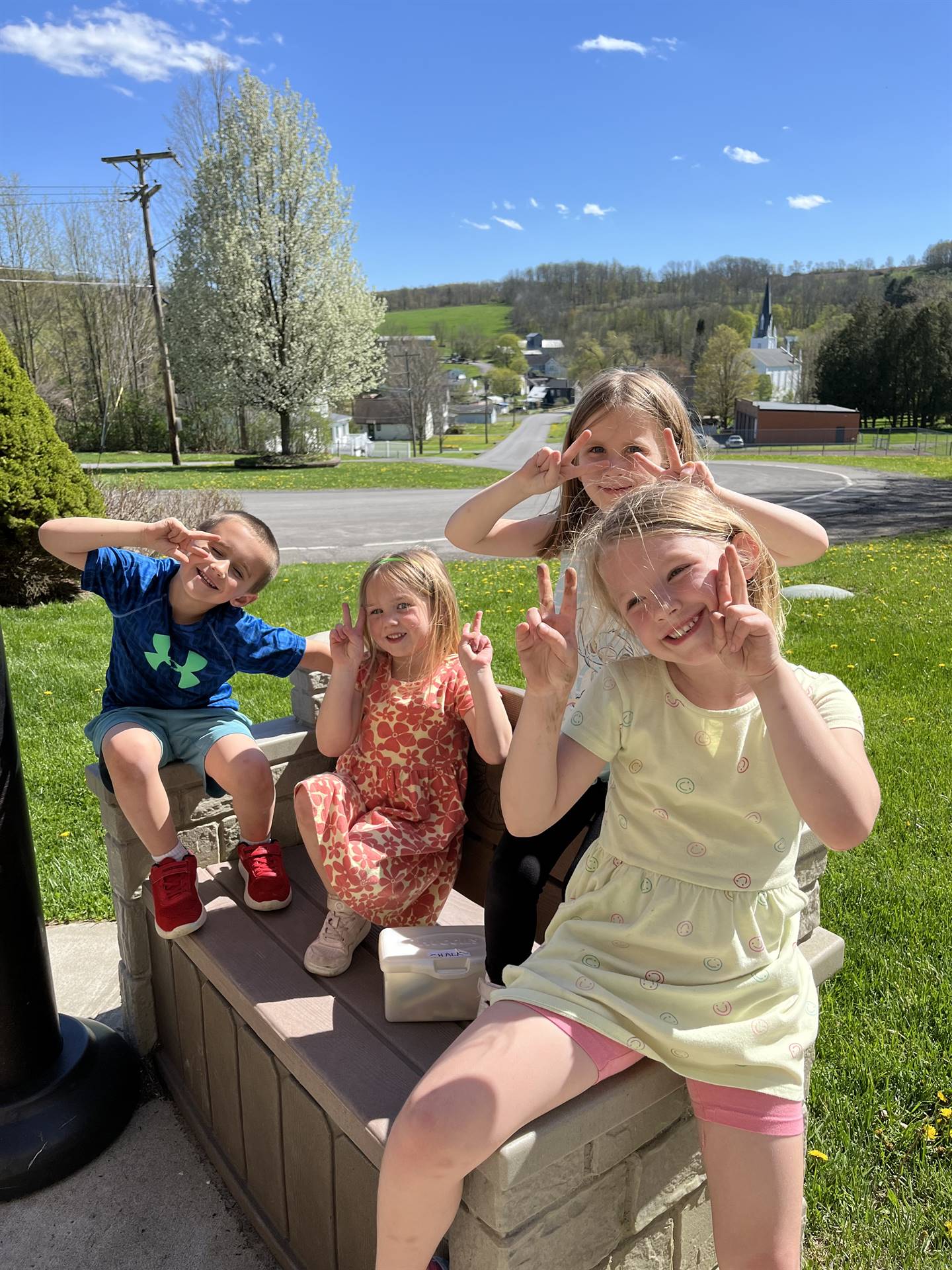 students outside sitting on a picnic bench