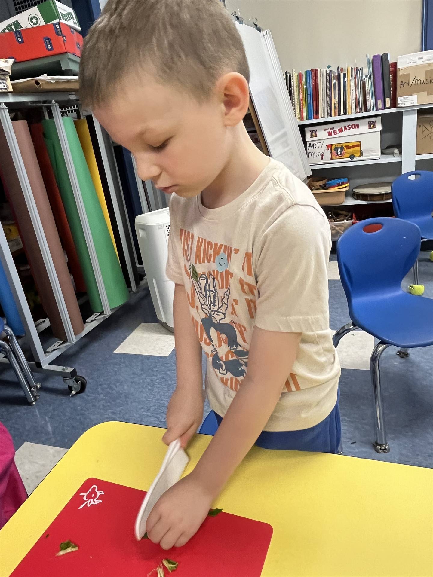 a student cutting up swiss chard greens.