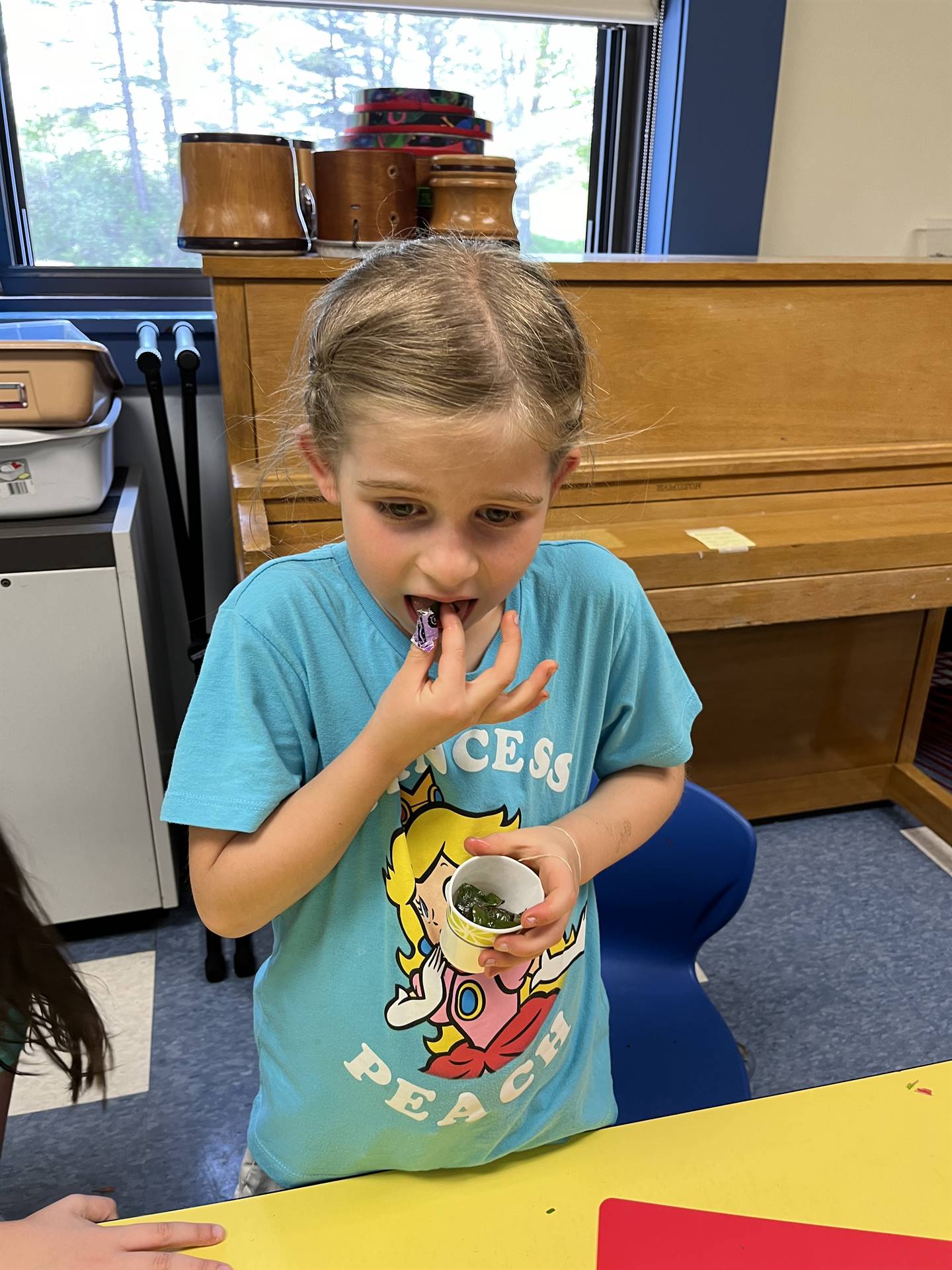 a student tastes  cooked swiss chard