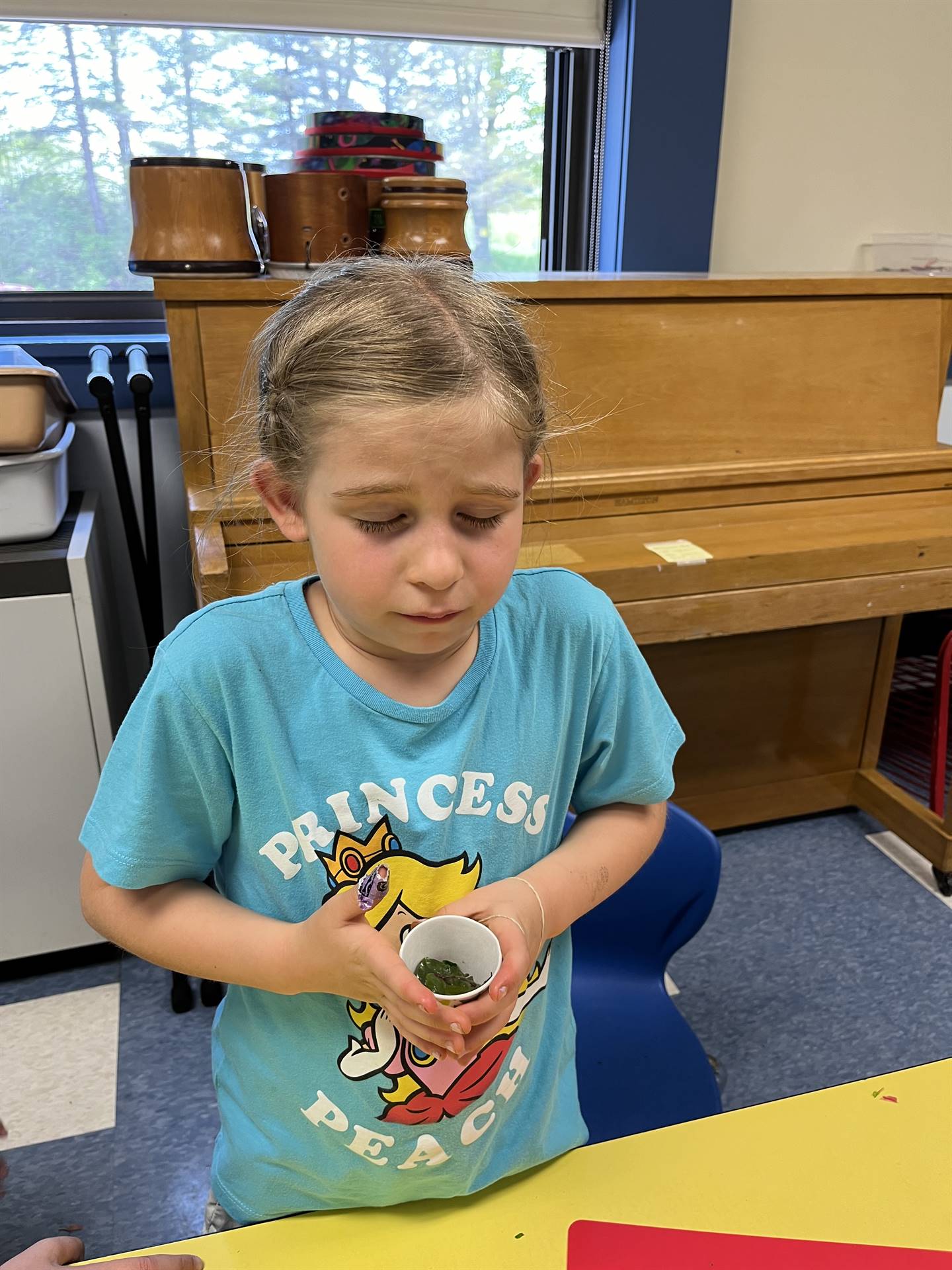 a student makes a face after tasting cooked swiss chard