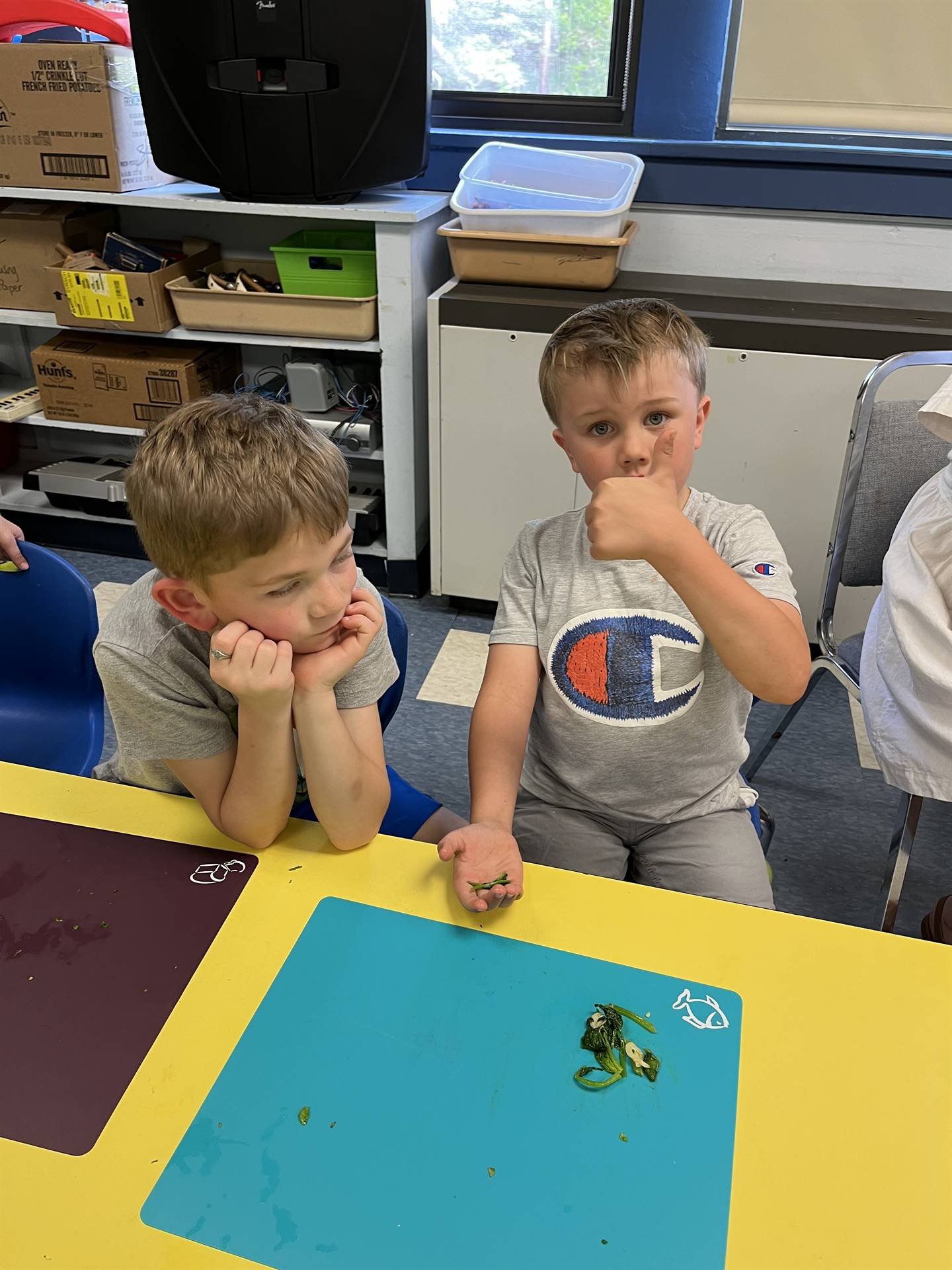 student gives thumbs up to cooked swiss chard.