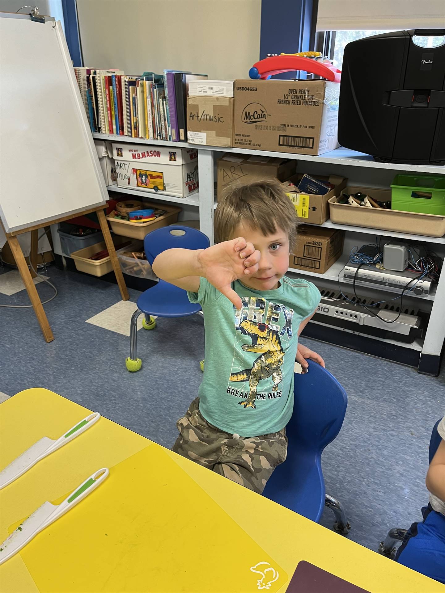 student gives thumbs down to cooked swiss chard.