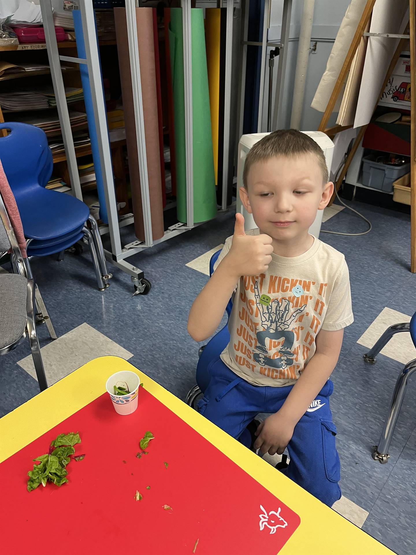 student gives thumbs up to cooked swiss chard.