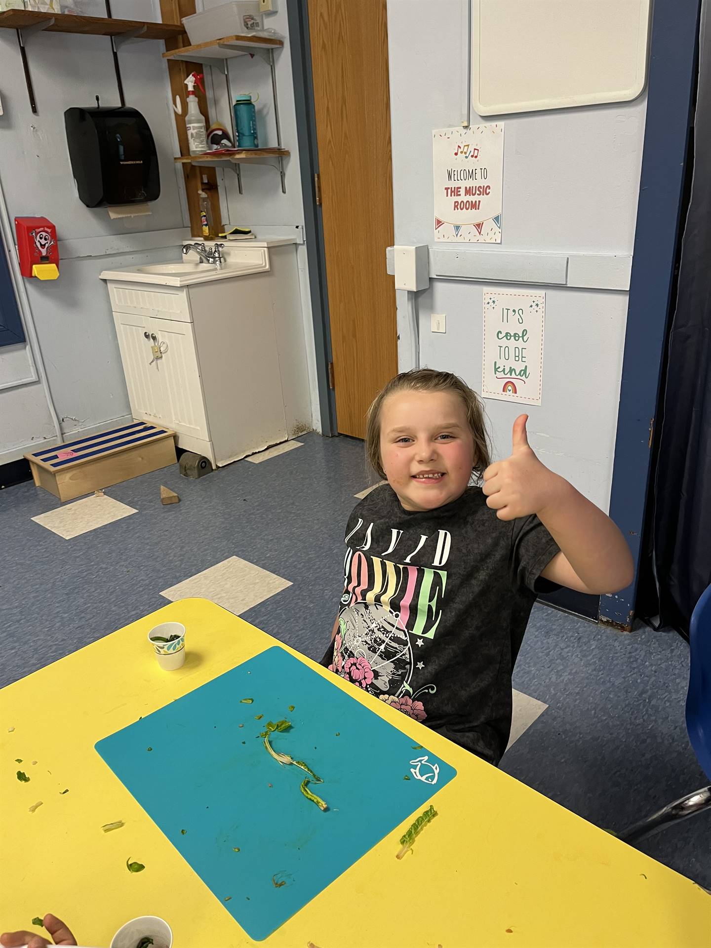 student gives thumbs up to cooked swiss chard.