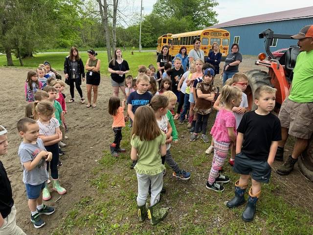 students outdoors with bus in background