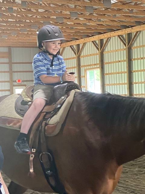 student sitting on a horse