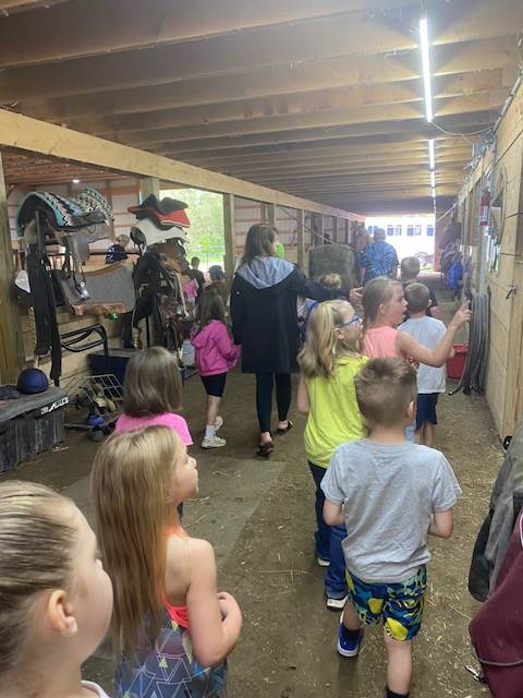 students in a horse barn