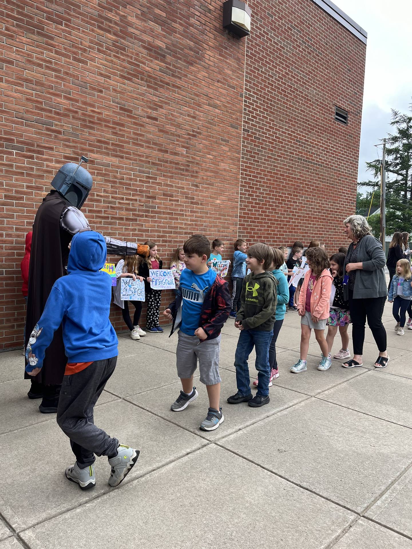 students being greeted by a star wars character