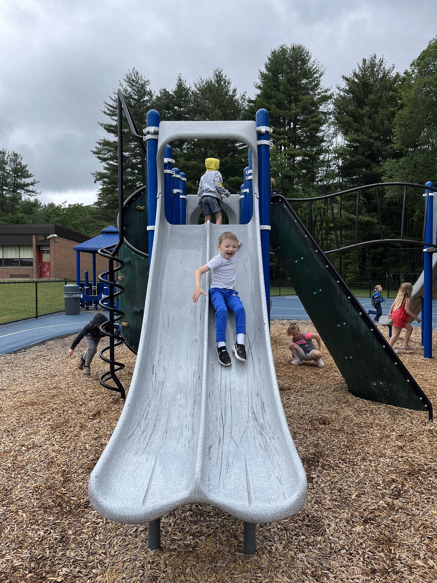 student sliding down slide