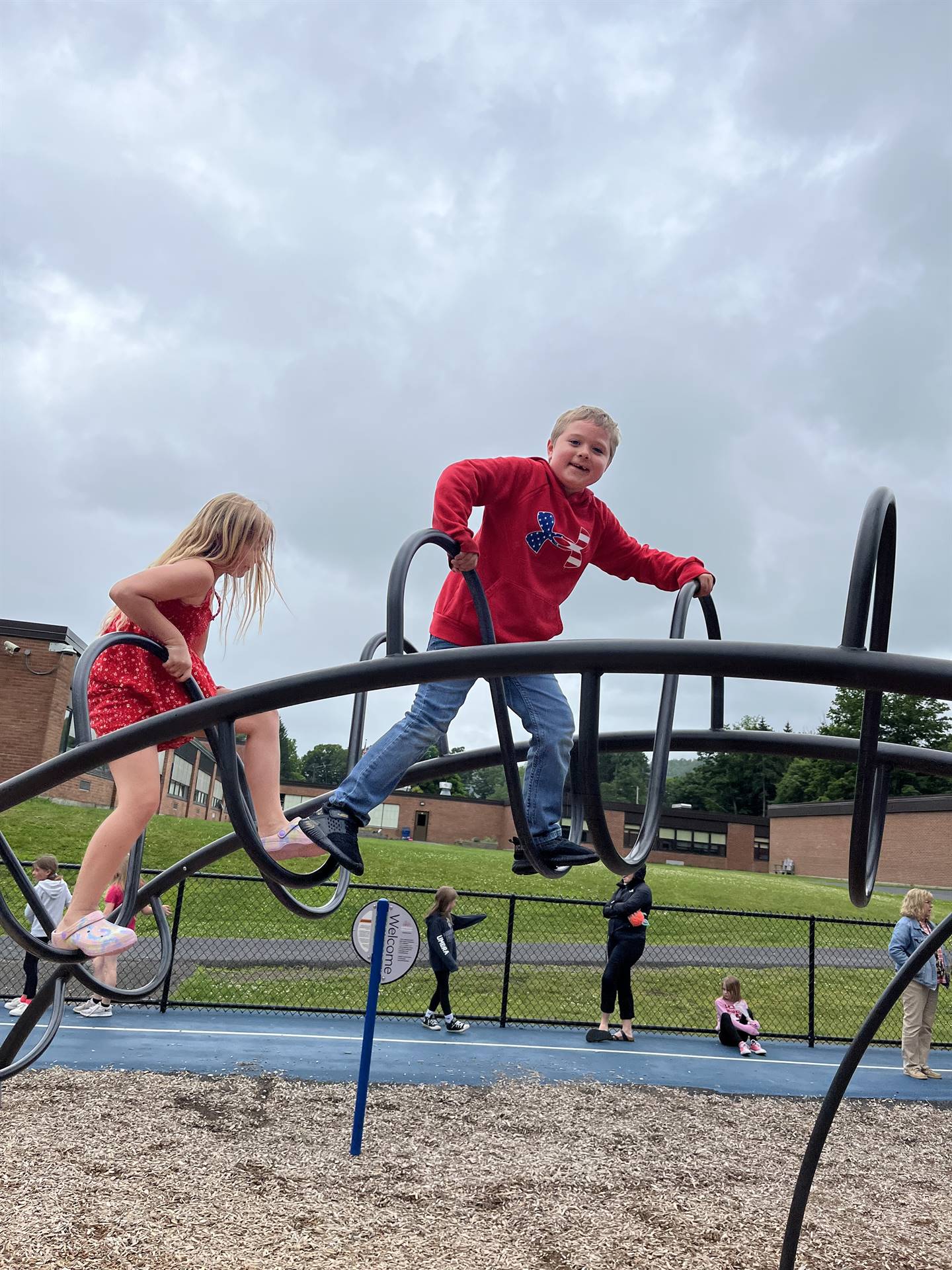students climbing on playground equipment