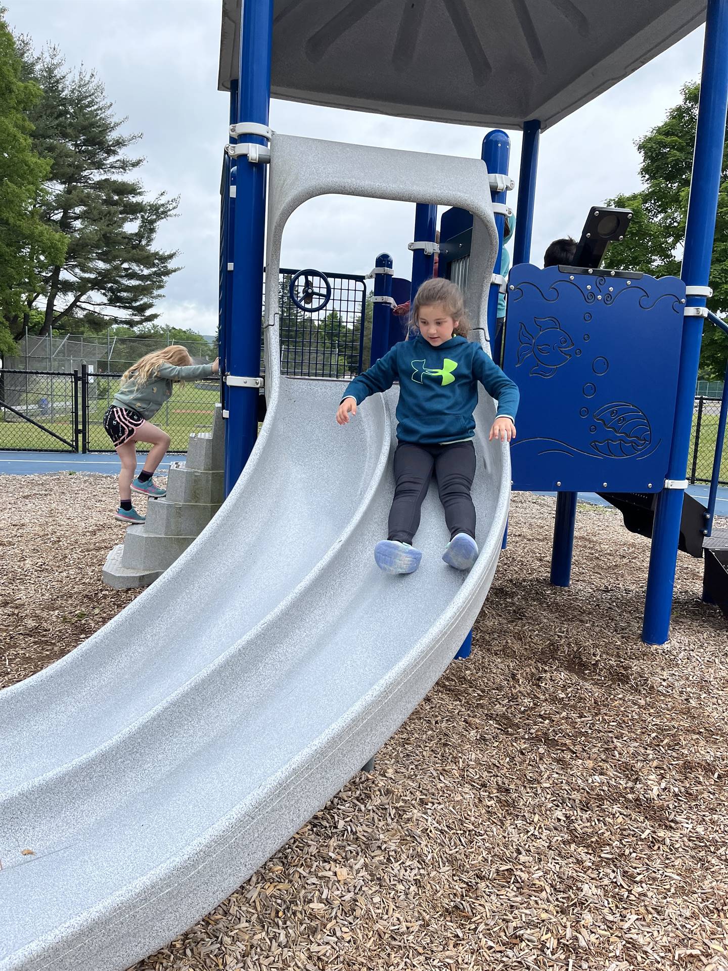 a student slides down slide
