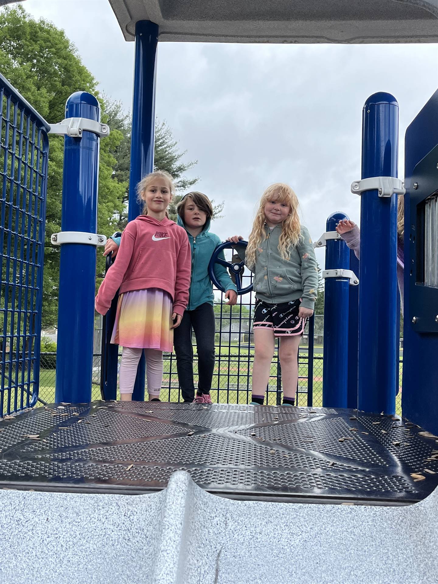 students climbing on playground equipment