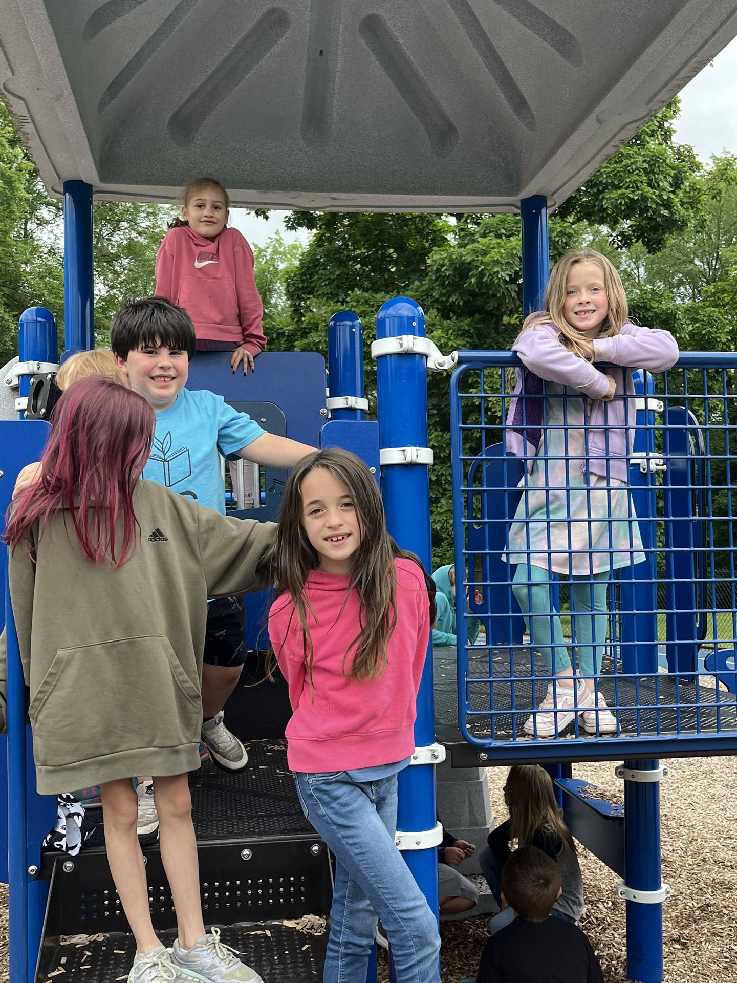 students climbing on playground equipment