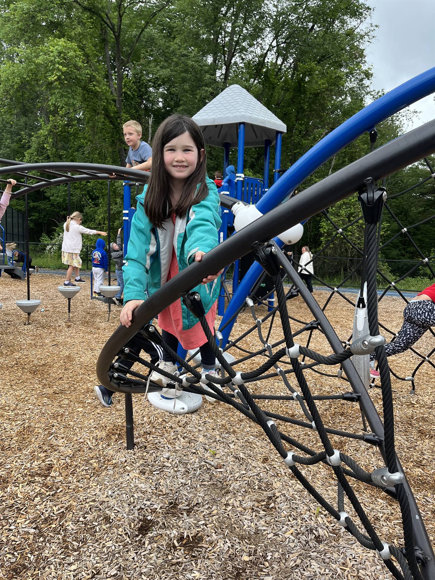 students climbing on playground equipment