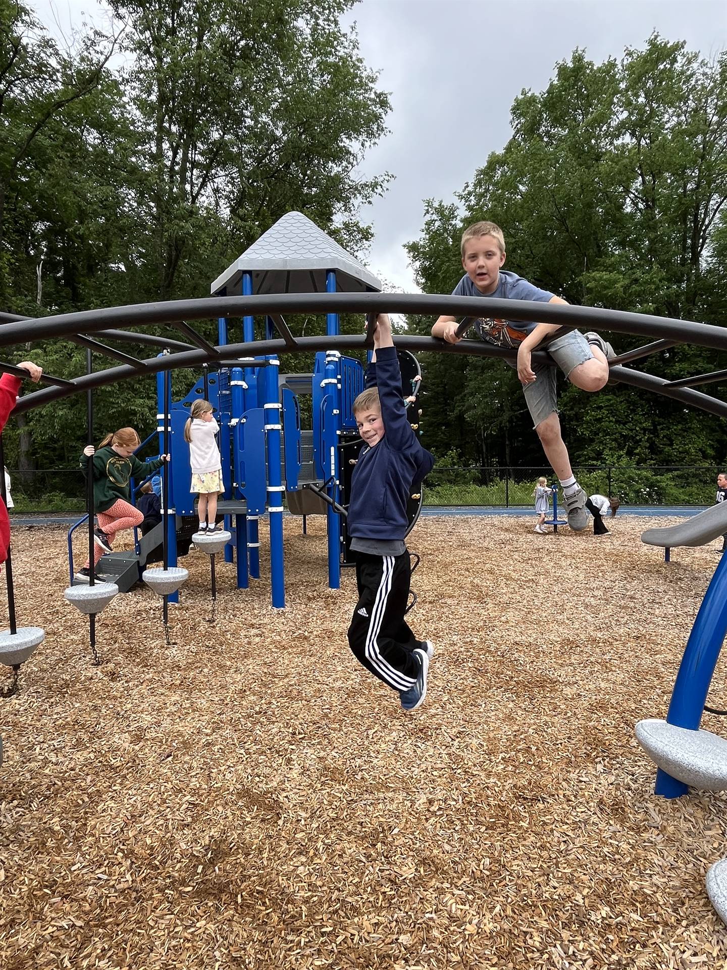 students climbing on playground equipment