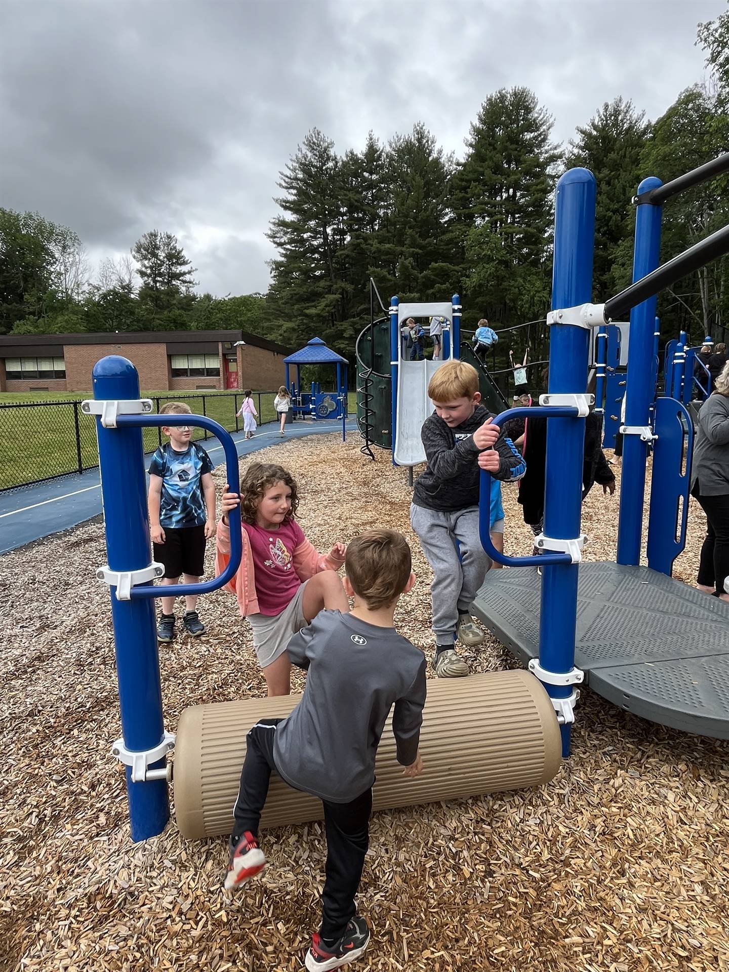 students climbing on playground equipment
