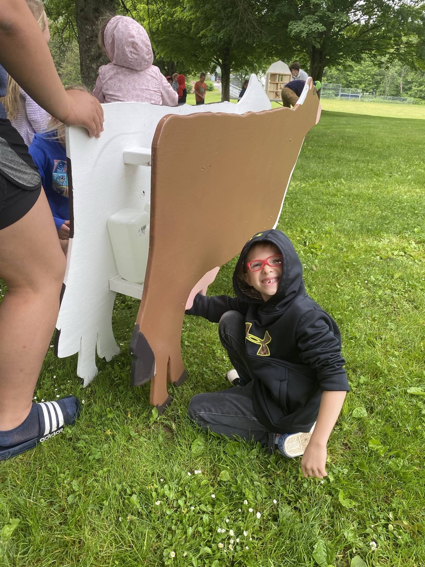 student practicing milking a pretend cow.