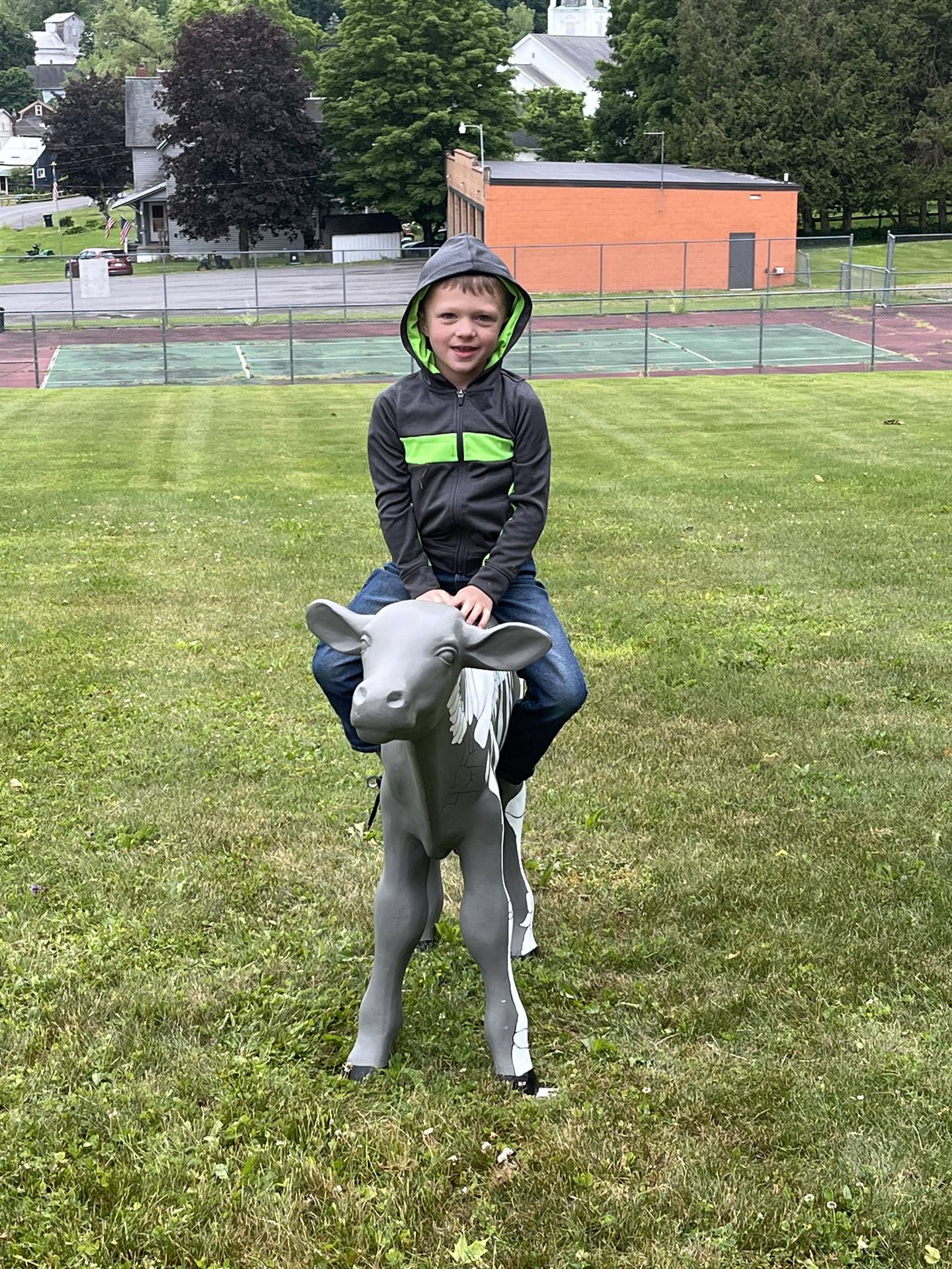 student sitting on a cow statue