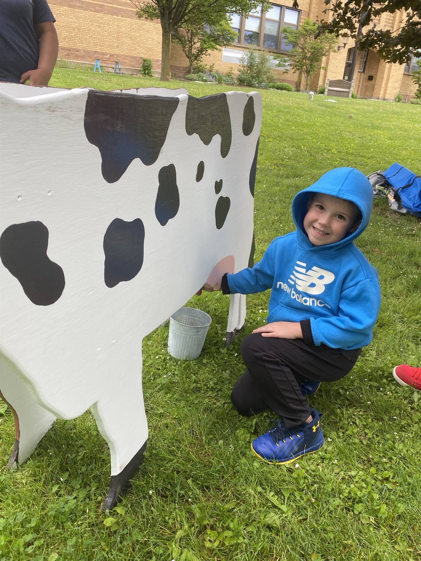 student practicing milking a pretend cow.