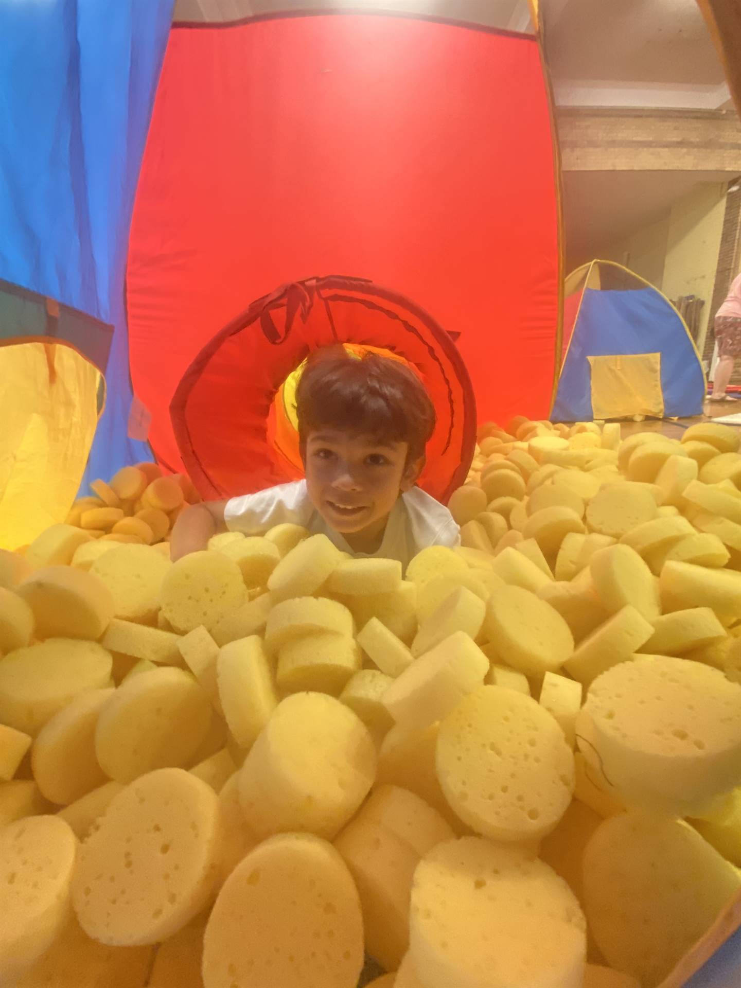 student in yellow ball pit