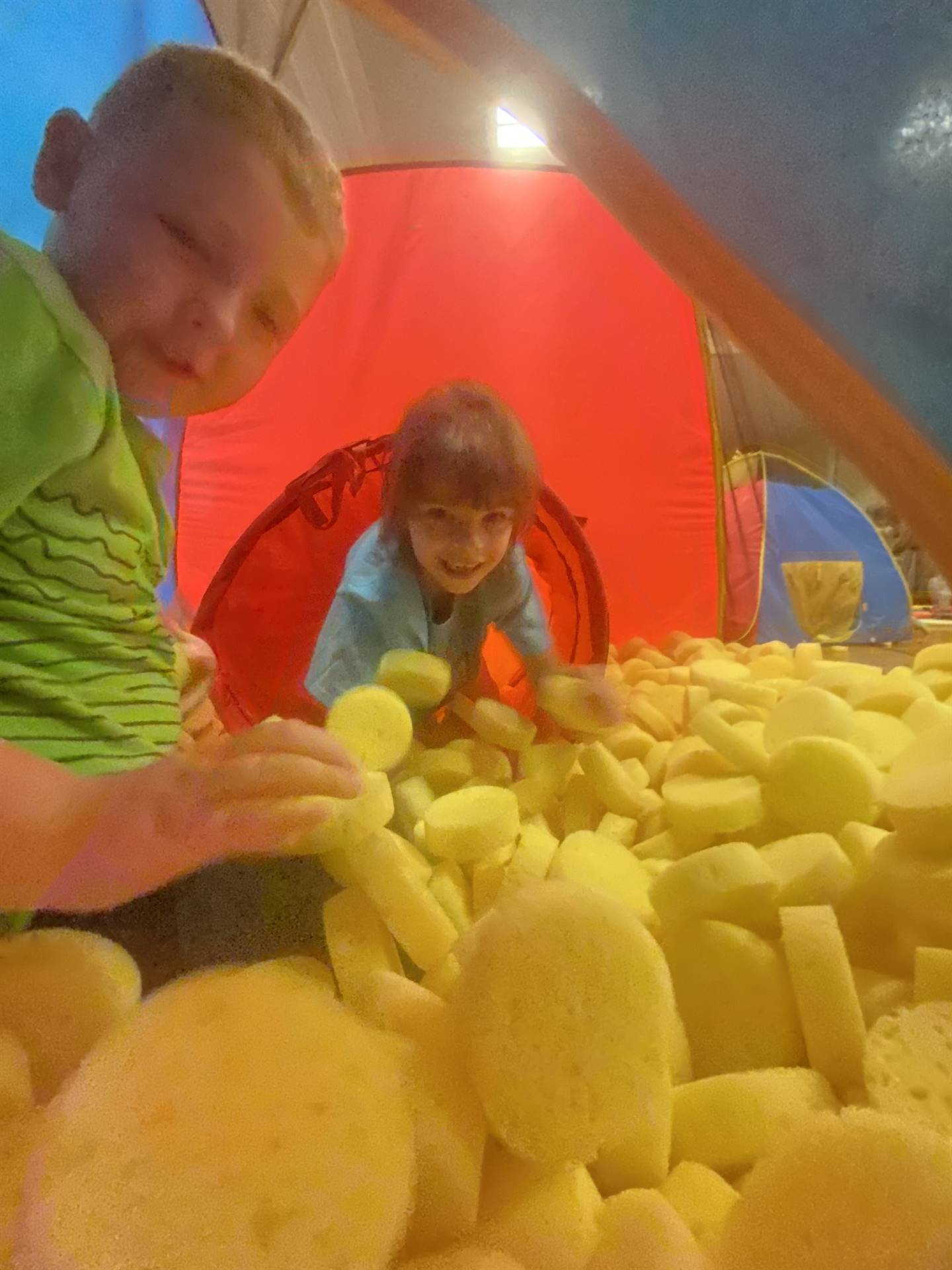 student in yellow ball pit